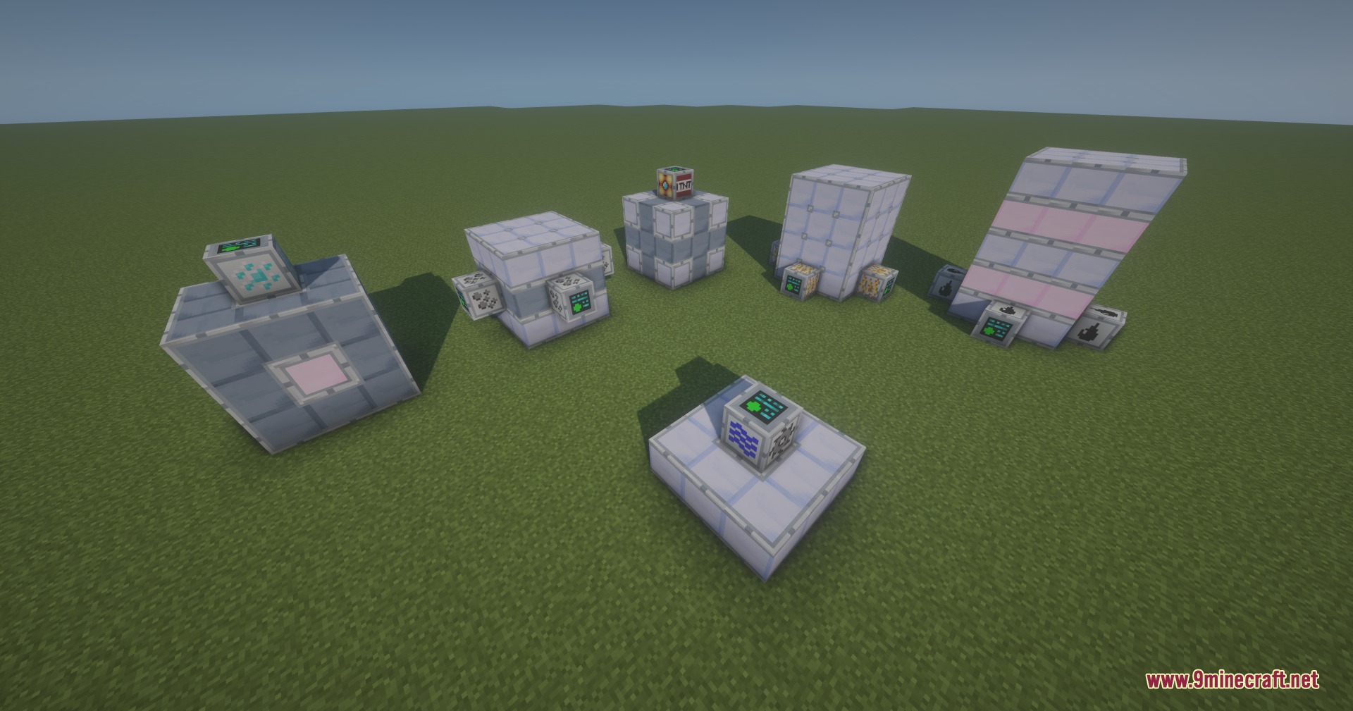 Different multiblock structures and machines displayed on a flat grass field