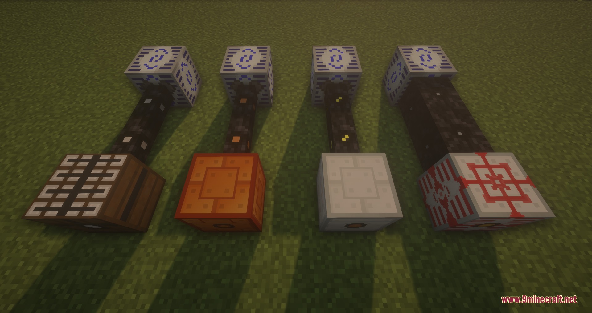 Four different industrial machine blocks connected by black pipes on the green grass