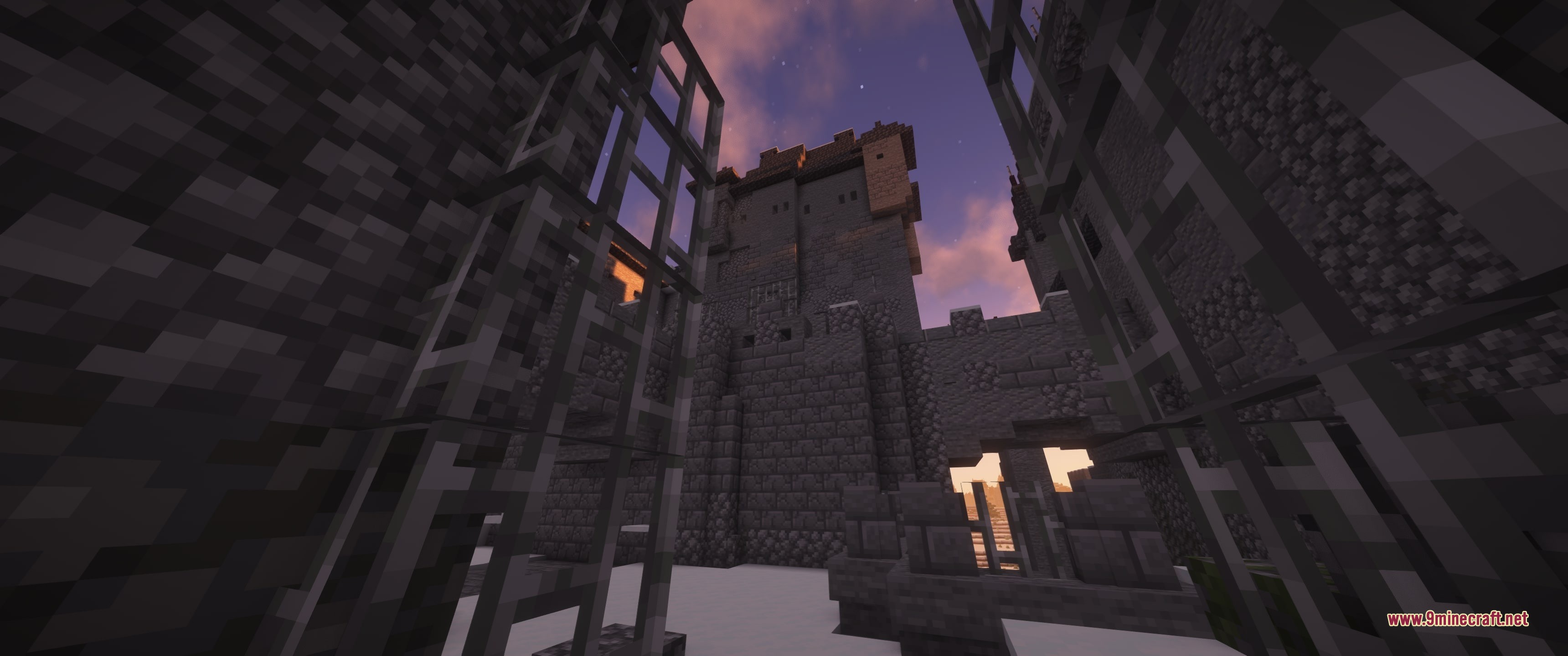 Grim Kingdoms Vanilla Edition Data Pack Screenshot 10 A view of a tall stone tower from behind iron bars at dusk