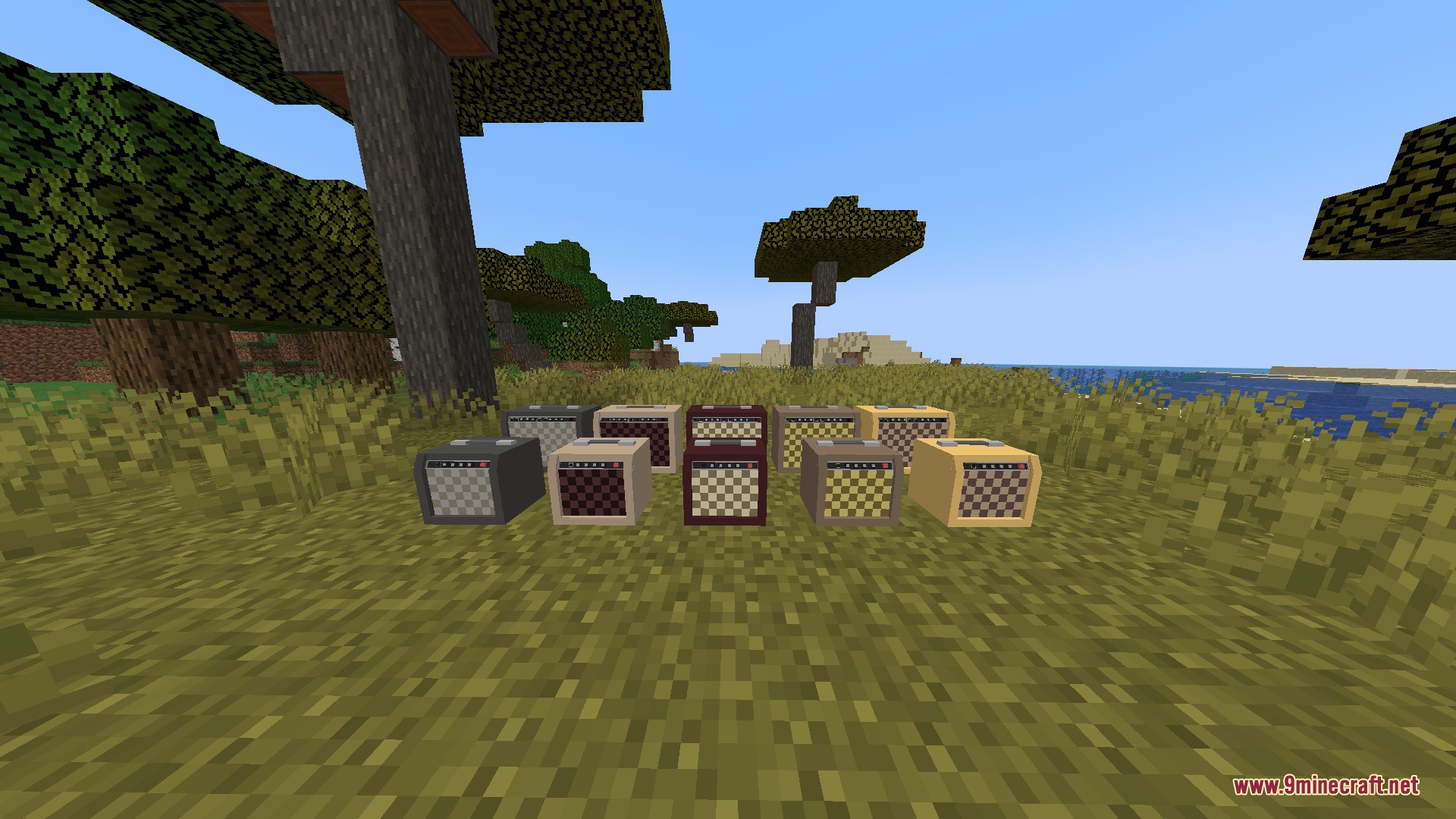 Guitars Mod Screenshot 8 Multiple colorful guitar amplifiers sitting on the ground in a savanna biome