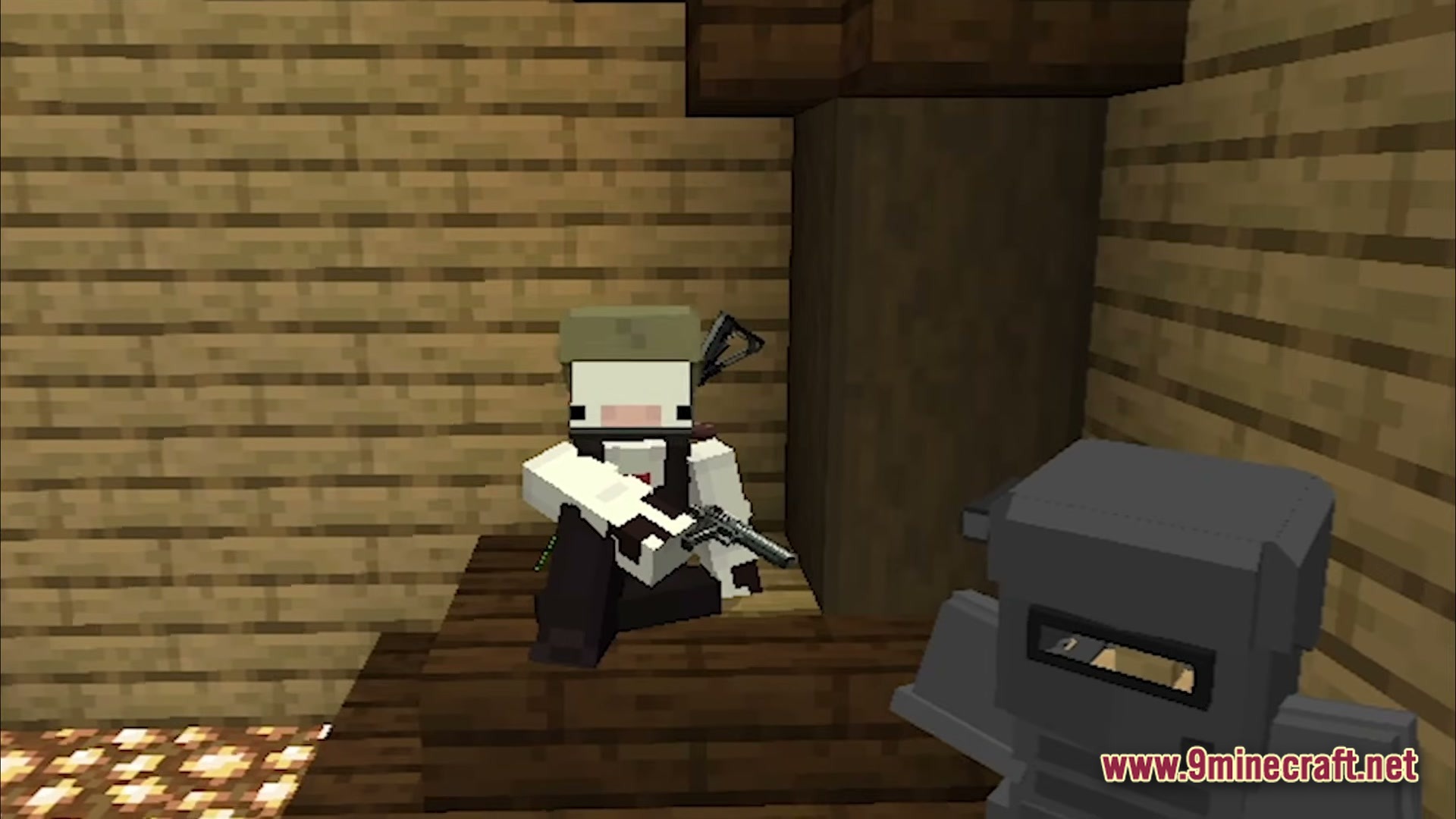 Guns And Poses GAP Modpack Screenshot 5 A player character in tactical gear holding a pistol while sitting inside a wooden structure