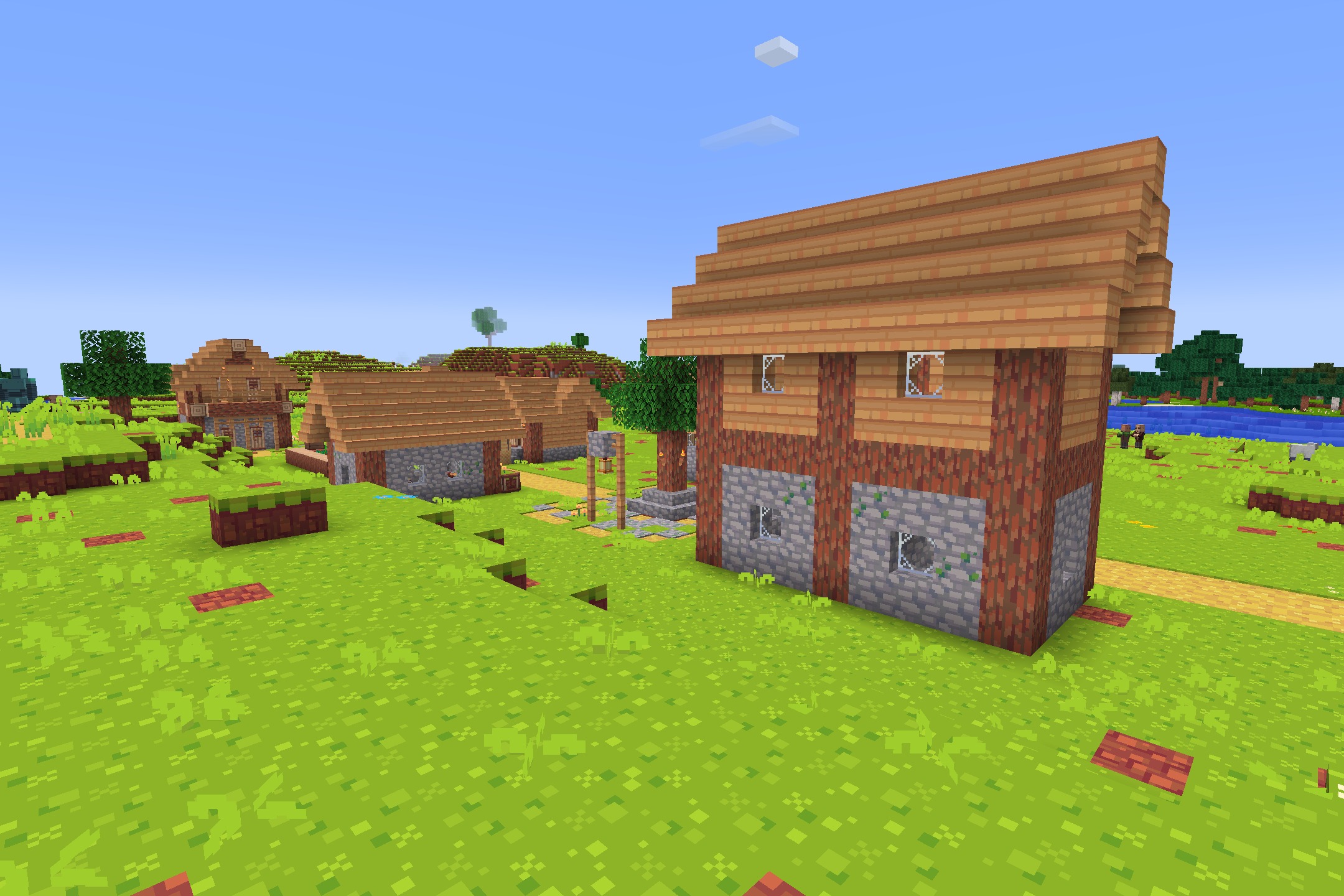 Hafen - Simplistic Resource Pack Screenshot 3 Simplistic village houses with bright colors and clean textures in a grassy field