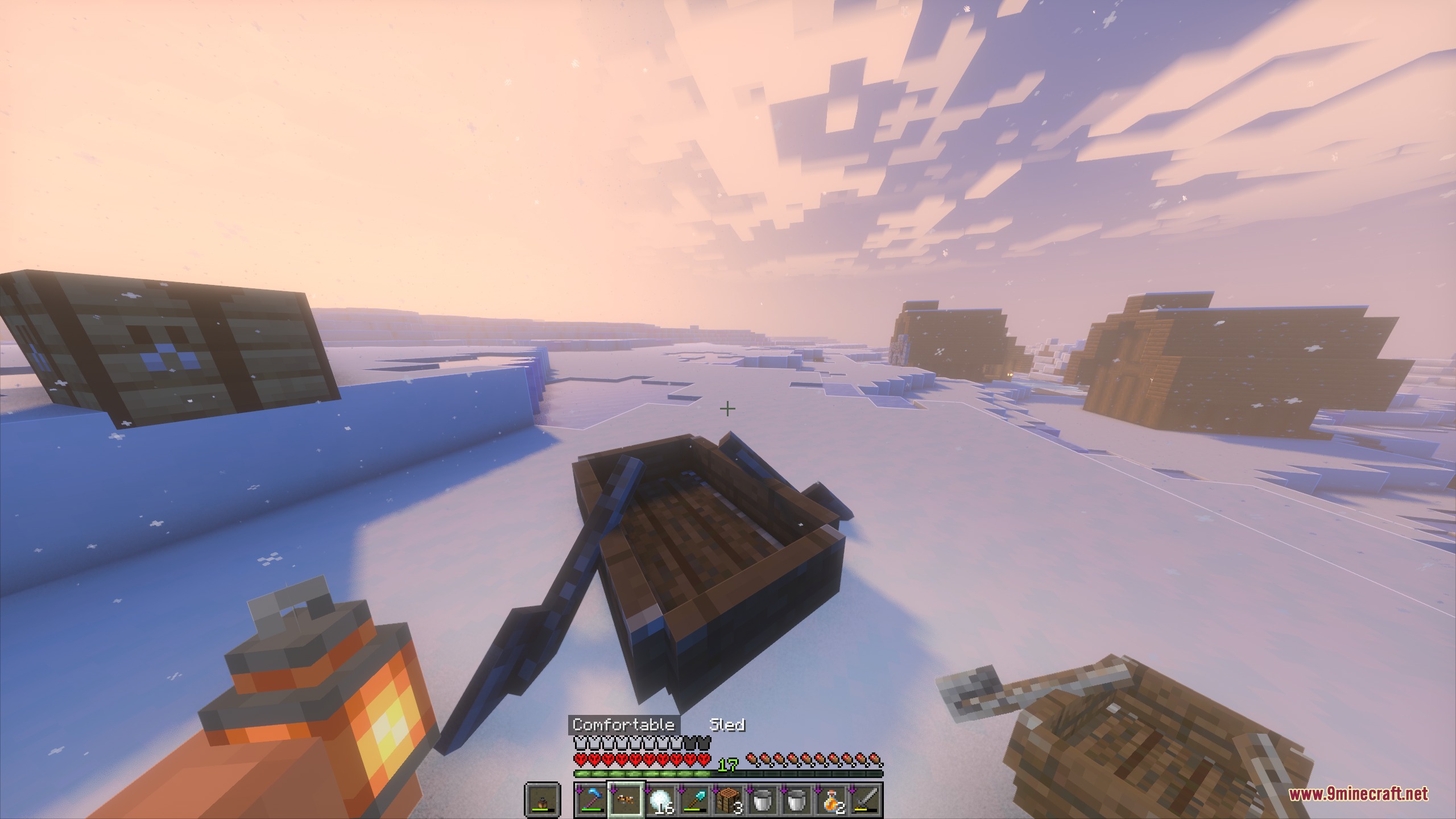 A player explores the frozen world with a lantern and a wooden sled