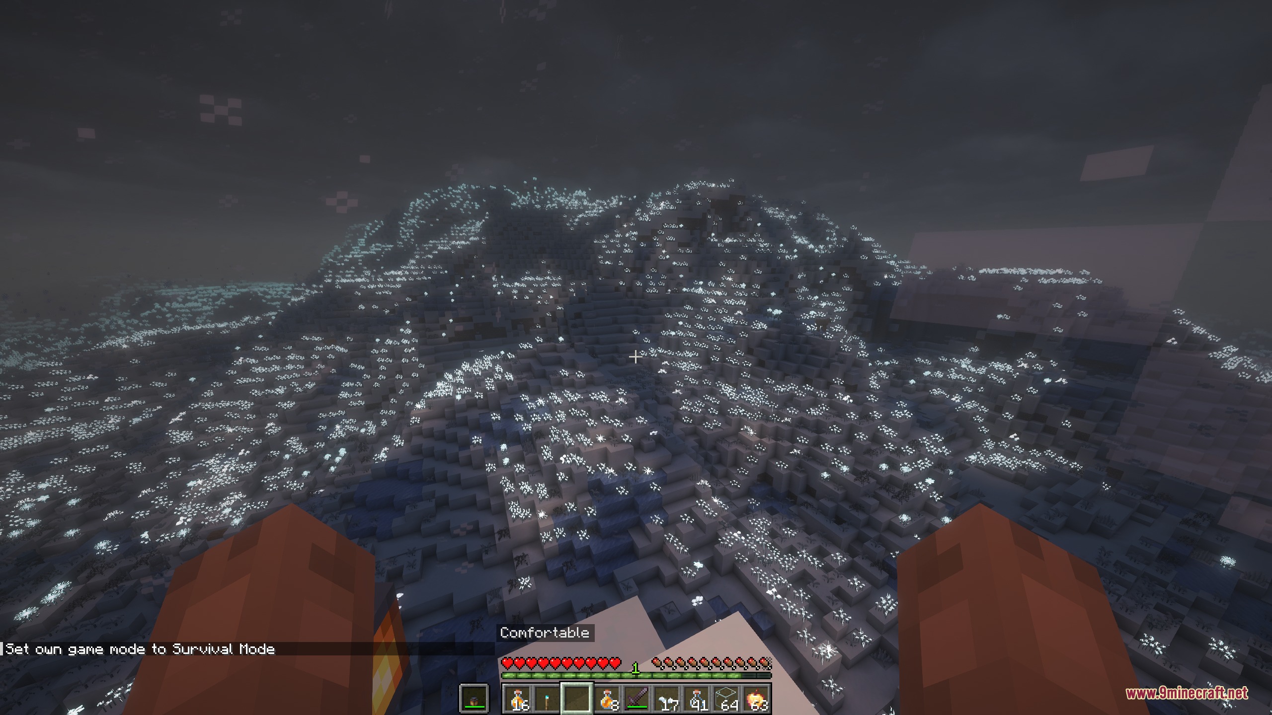 Glowing lights illuminate a massive snowy mountain under a dark winter night sky