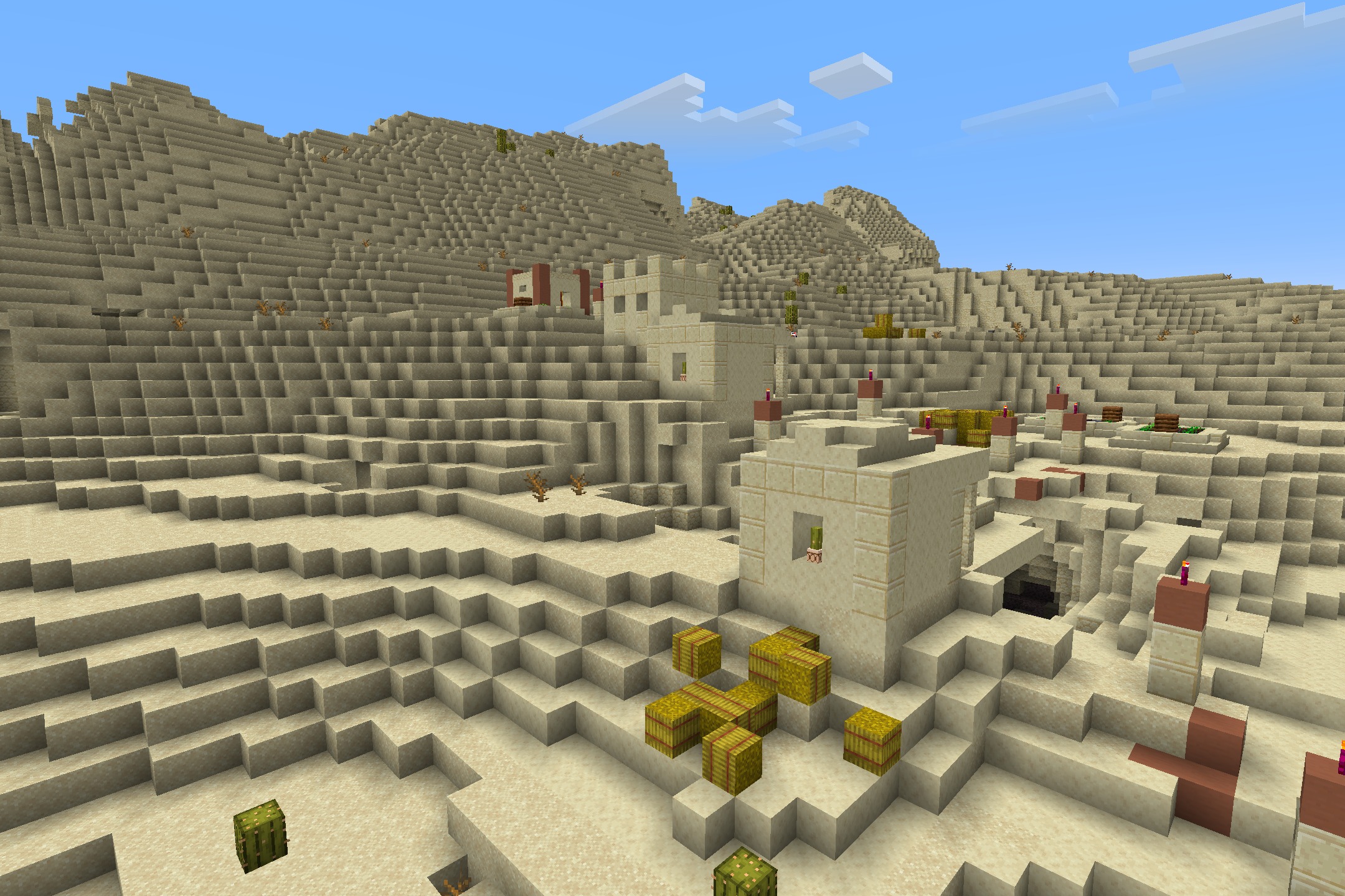 Hazbin Hotel + Helluva Boss Pack Resource Pack Screenshot 5 Sandstone houses and hay bales in a desert village under a blue sky