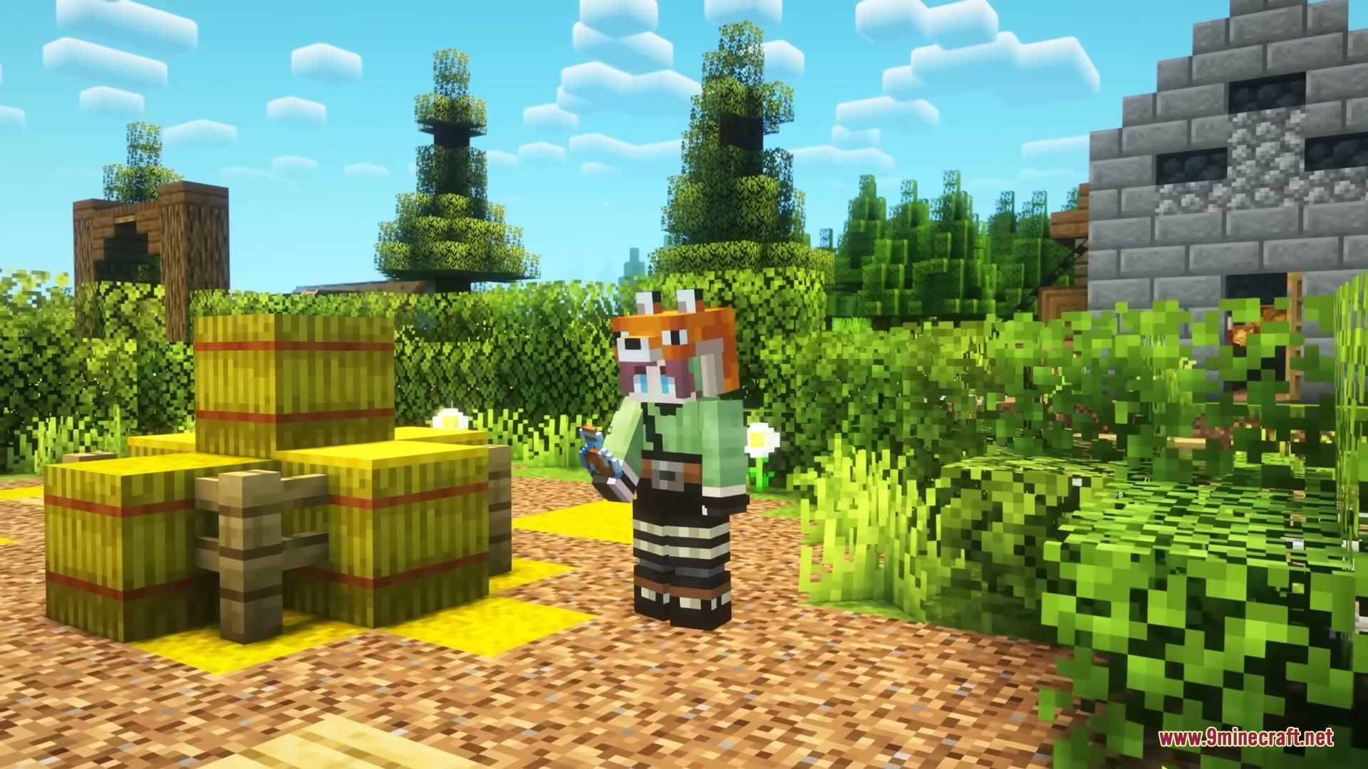A player wearing a fox hat stands near hay bales and bushes