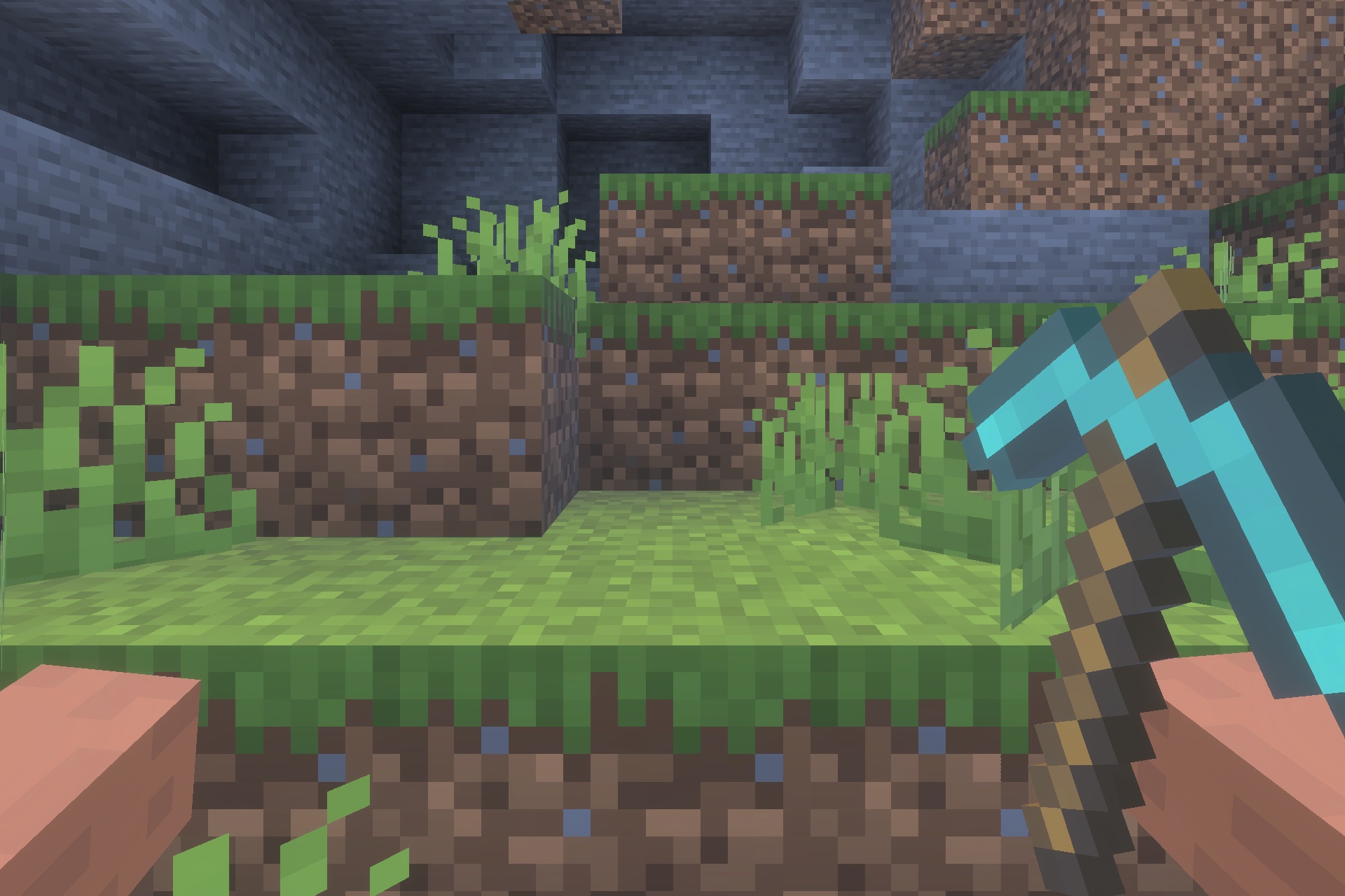 A player holding a diamond pickaxe in a grassy Minecraft world area