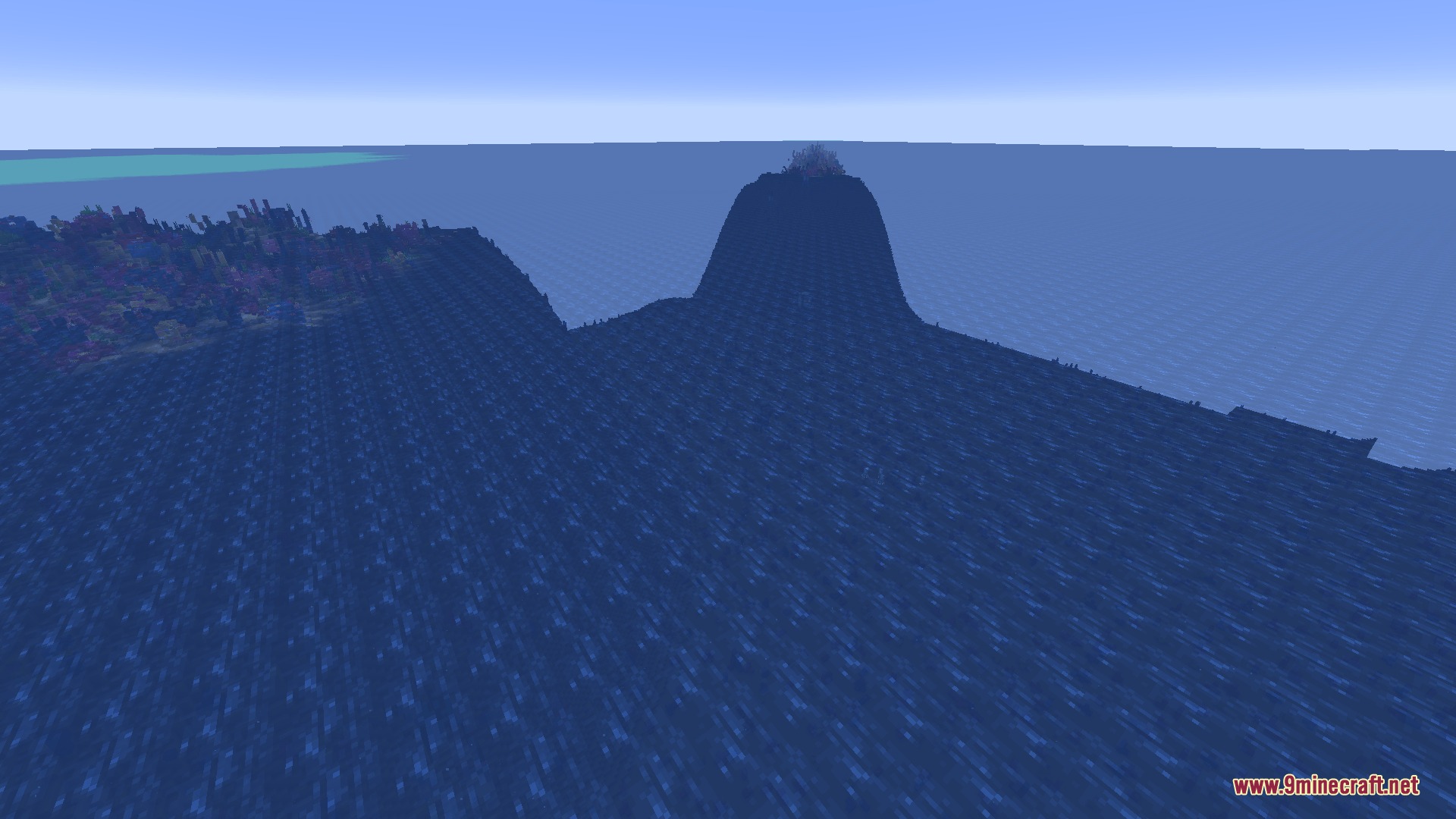 A coral reef sits next to a massive deep ocean trench formation