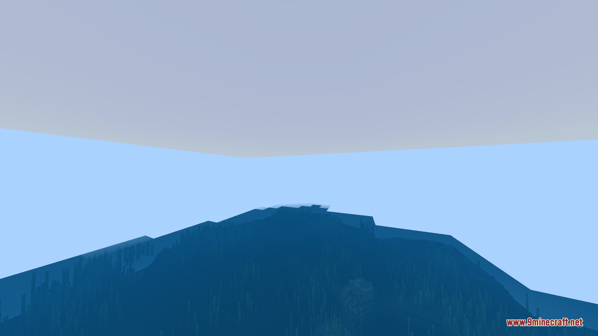 A wide view of the deep blue ocean with natural sky colors above