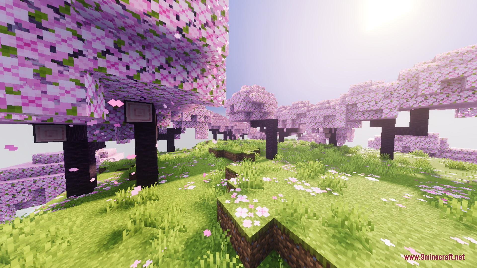 Lush cherry blossom forest with pink petals and bright sunlight in Minecraft