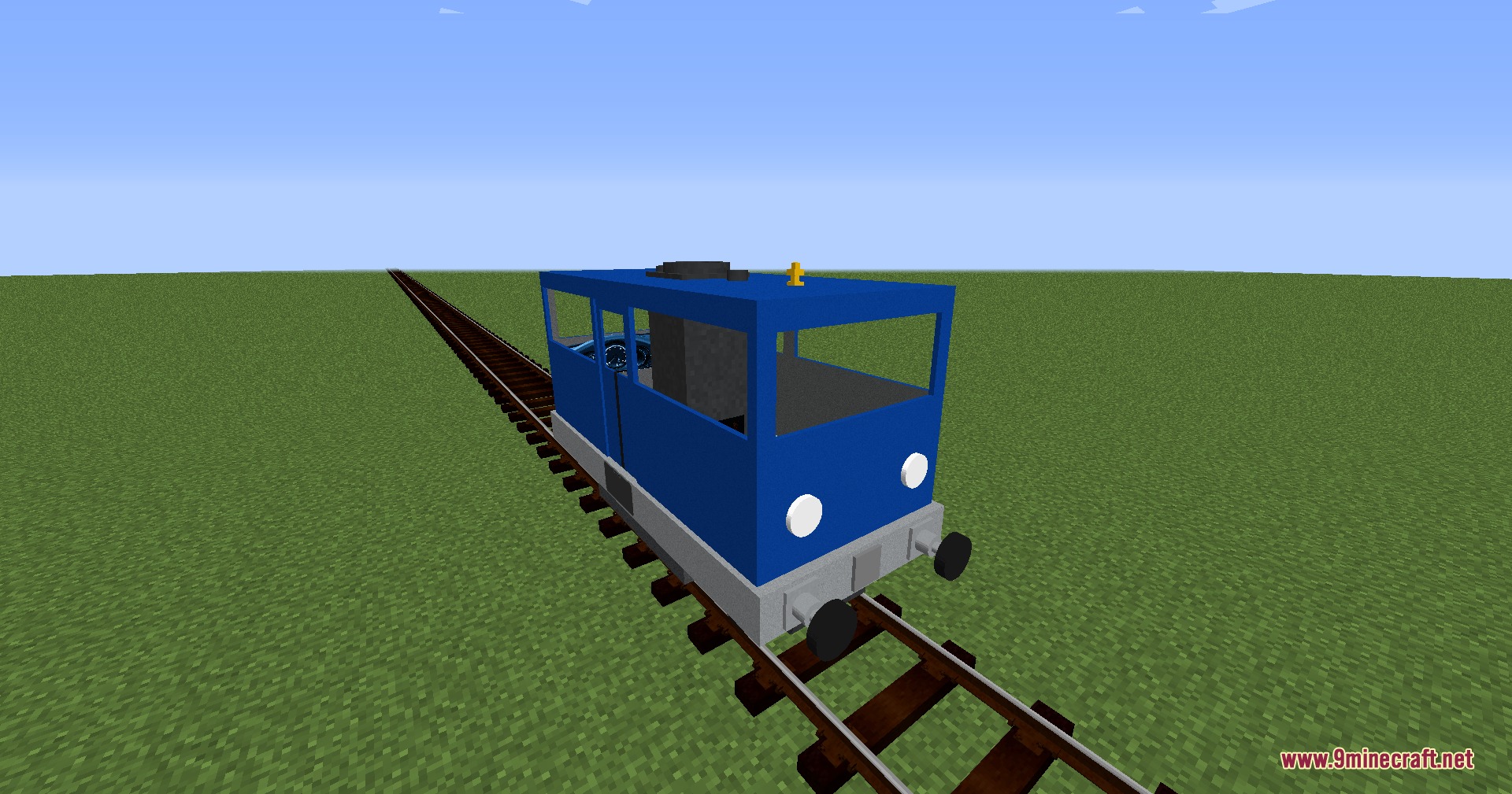 A small blue railcar sitting on a track in a flat world