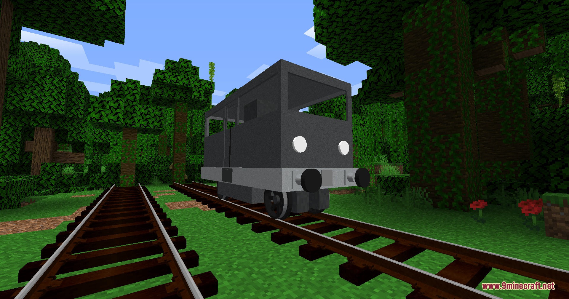 A small grey railcar sits on railroad tracks in a Minecraft jungle biome