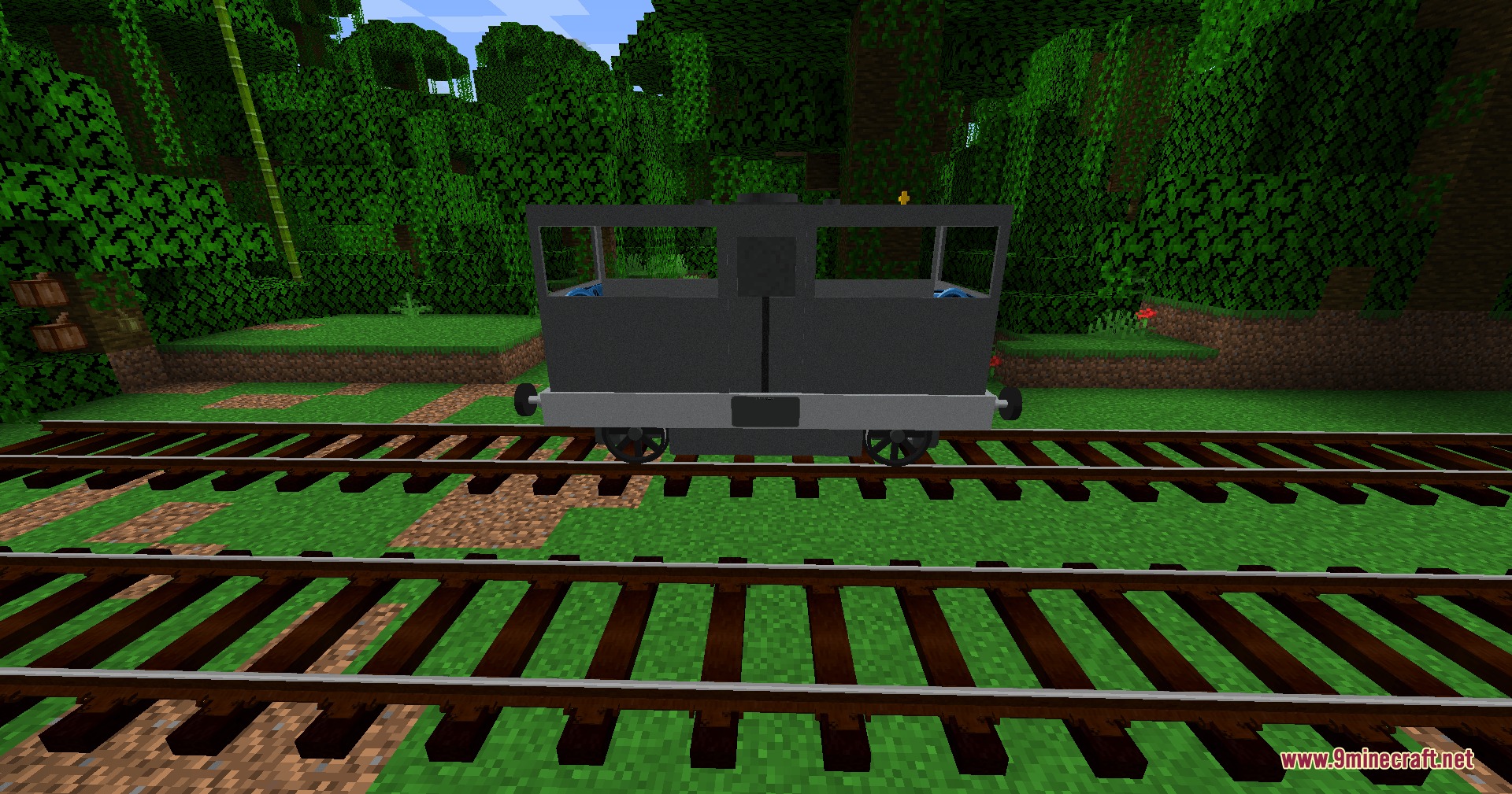 Side view of a grey railcar on tracks in a Minecraft jungle environment