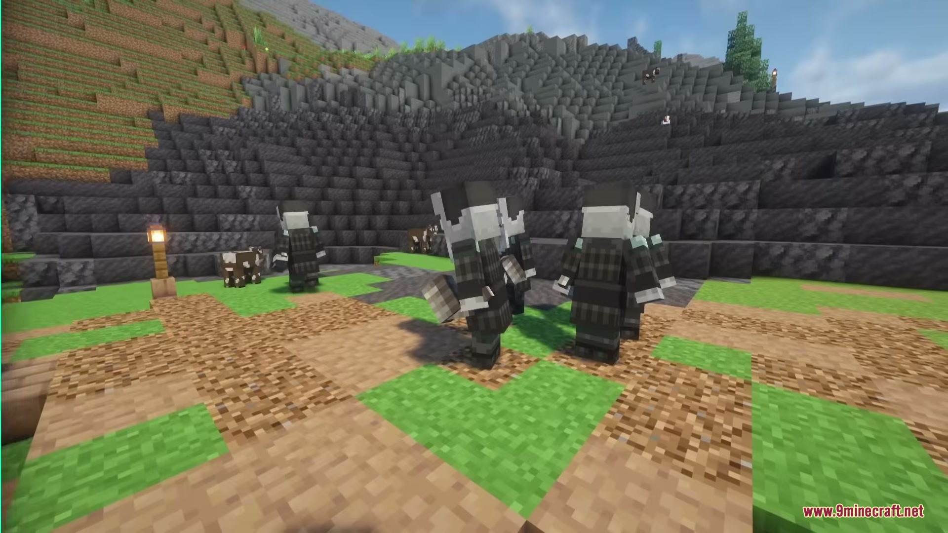 Illager Universe Mod Screenshot 1 A group of armored Upgraders standing on a grassy field near mountains