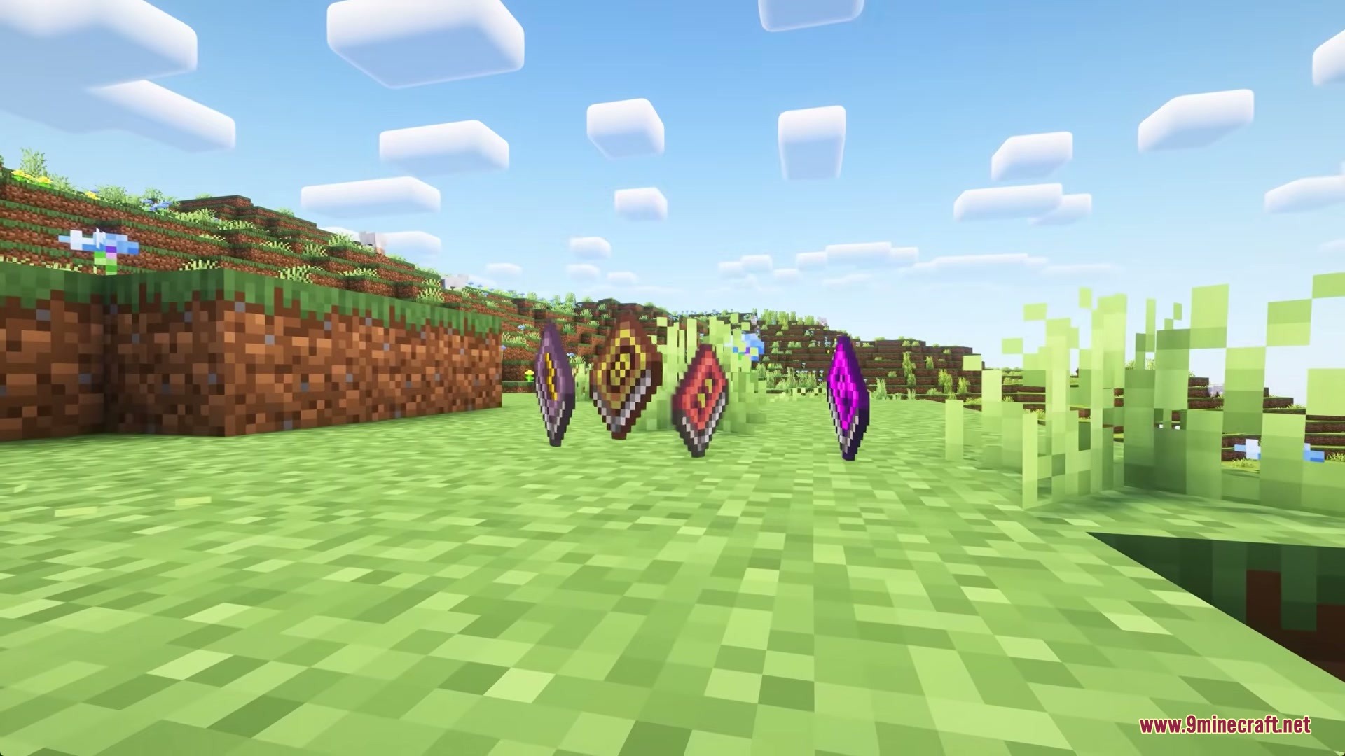 Illusion Onslaught Mod Screenshot 7 Four colorful elemental spellbooks floating on the grass in a sunny Minecraft world