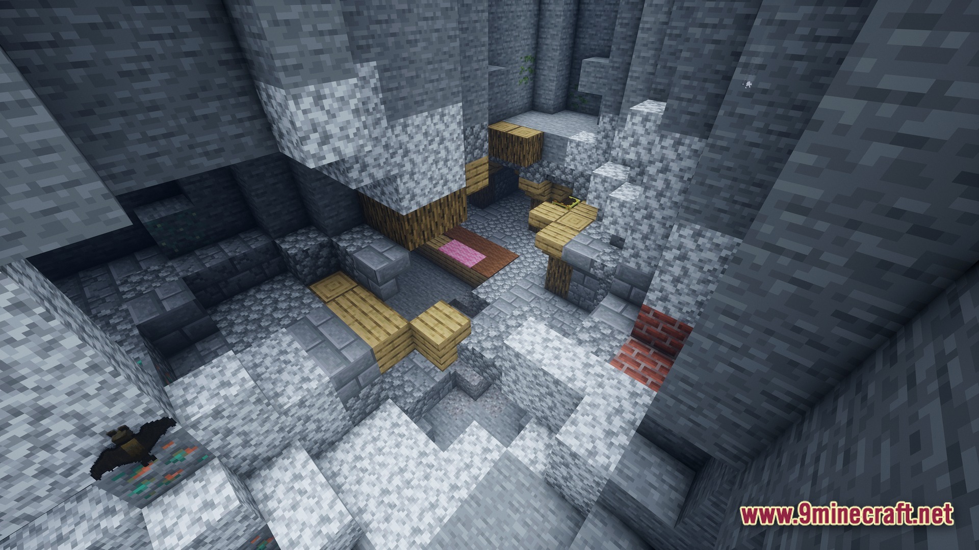 A rocky underground cavern featuring wooden structures, various ore blocks, and a flying bat