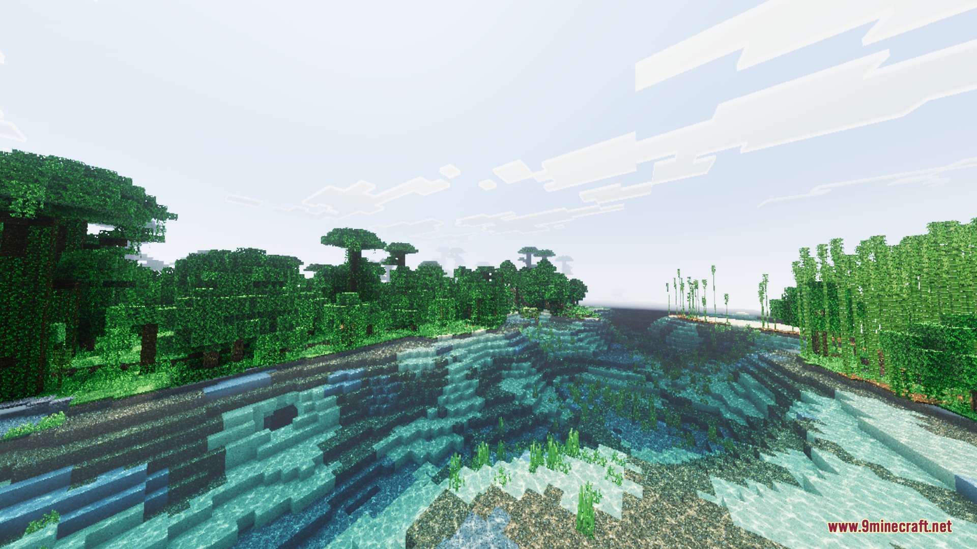 Lush jungle trees and bamboo stand beside a river with realistic water reflections