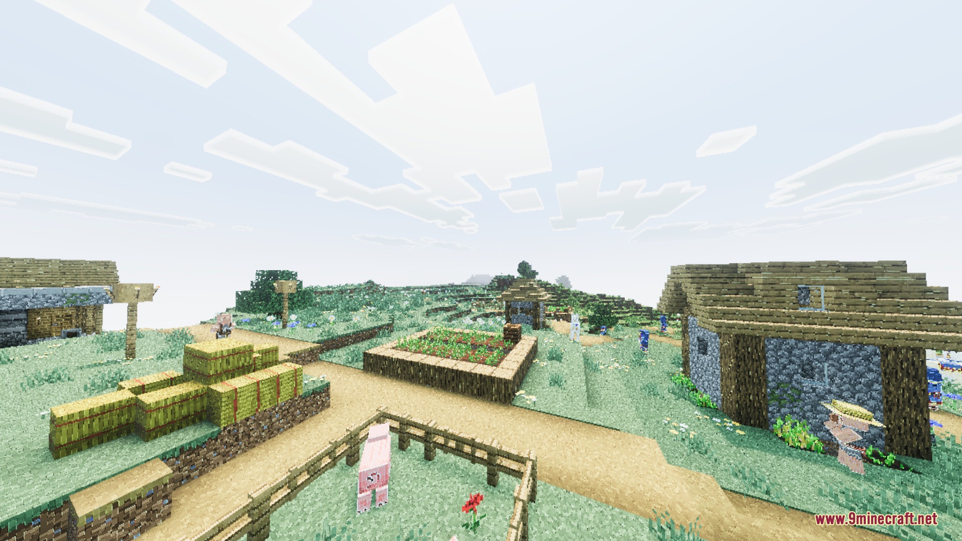 A peaceful Minecraft village with vibrant lighting and hay bales in a field