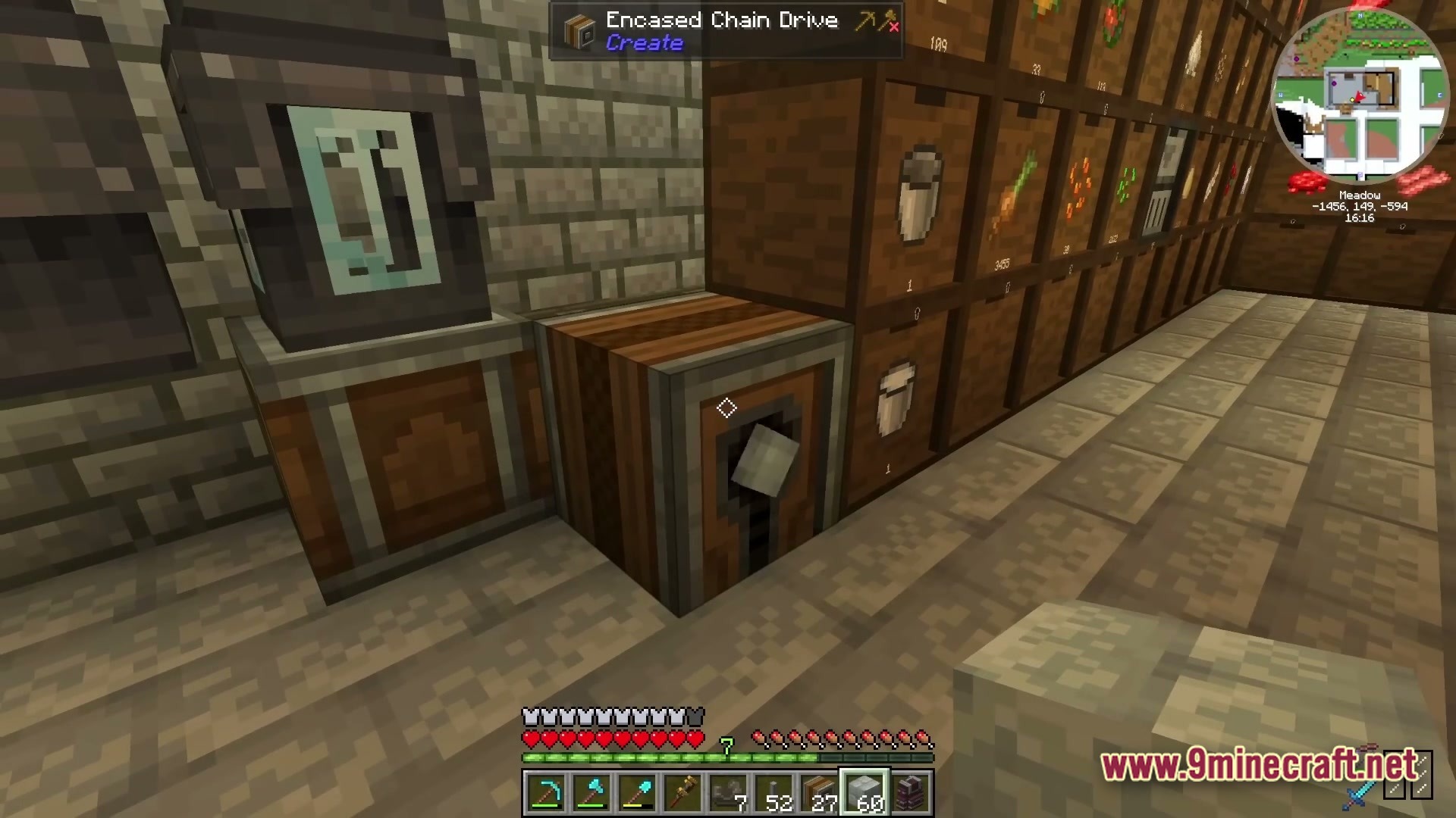 Industrial Banquet Crucible Modpack Screenshot 1 An Encased Chain Drive from the Create mod placed next to a storage drawer wall