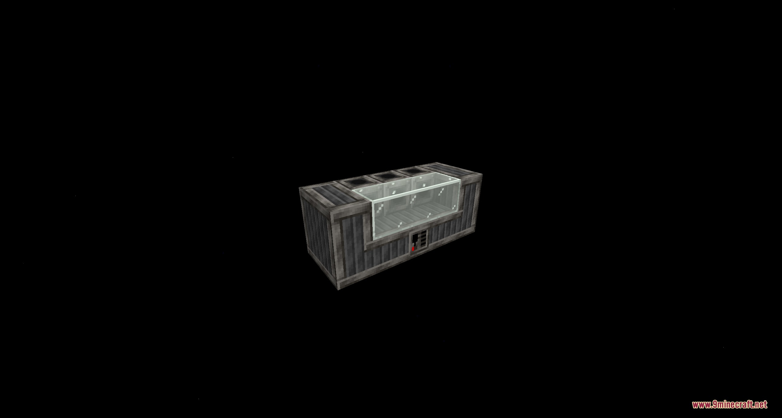 A dark gray industrial machine block with a transparent glass viewing window