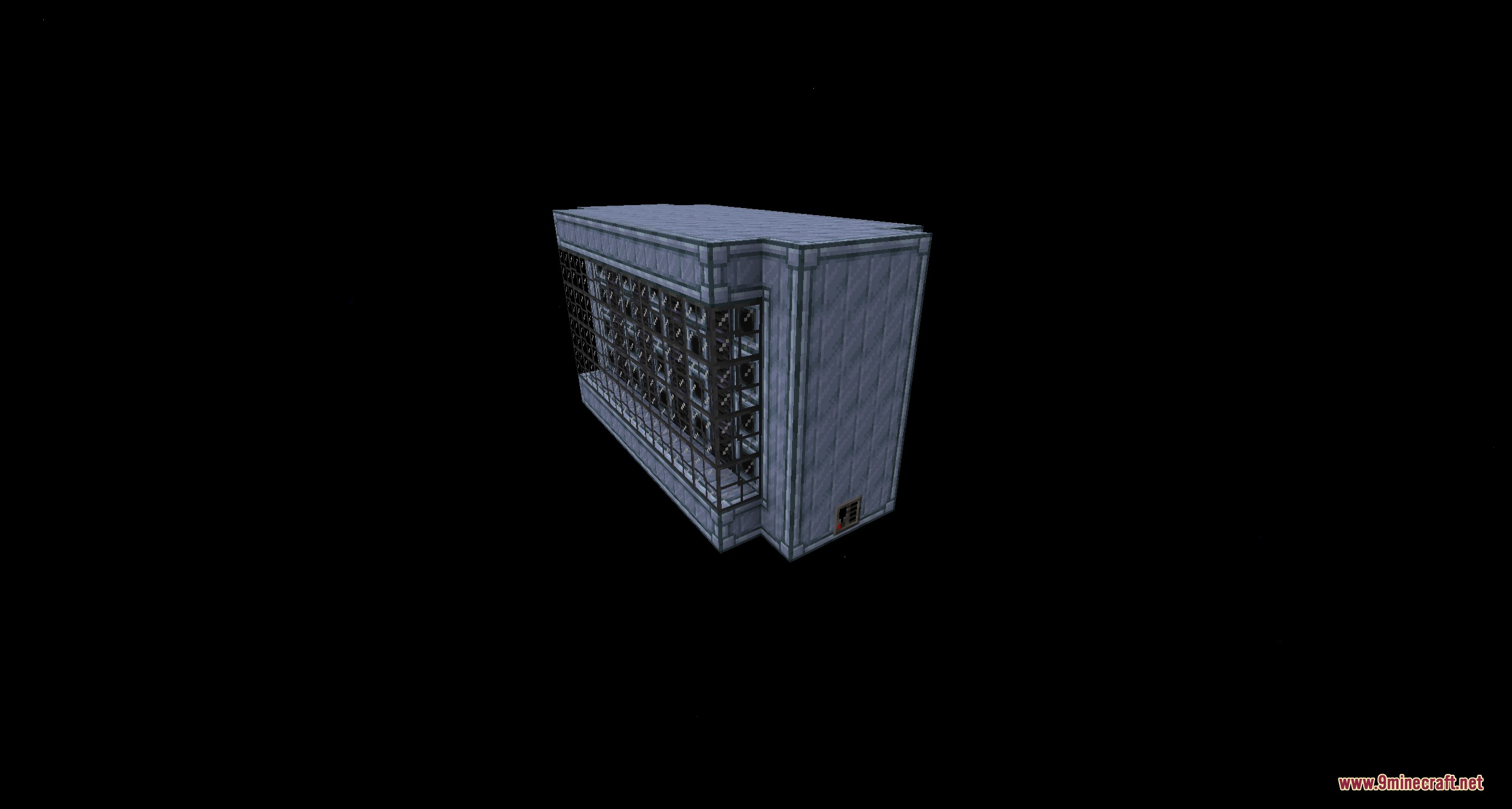 A large industrial multiblock machine with glass panels in a dark void