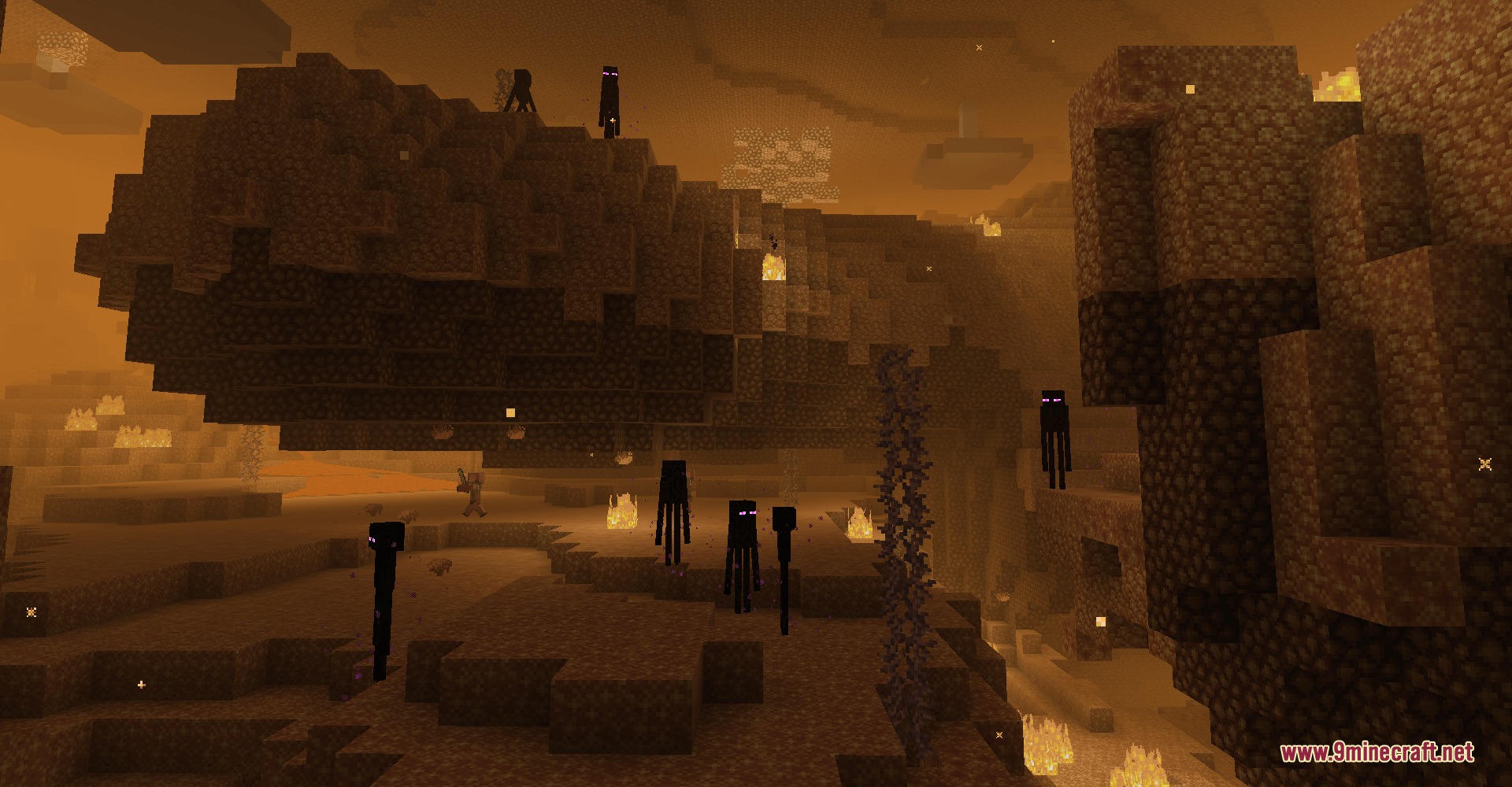 Infernal Expansion Redux Mod Screenshot 1 Endermen standing near a massive whale shaped stone structure in a foggy canyon
