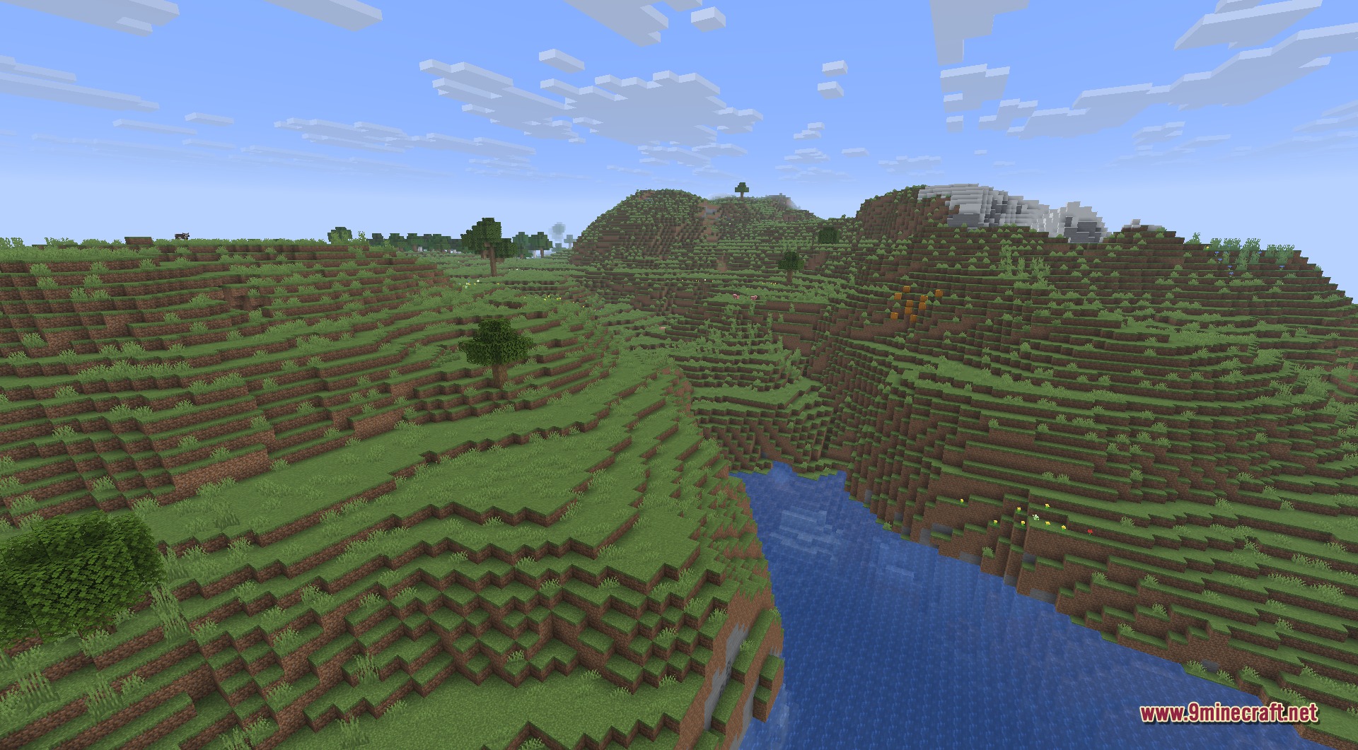 Infinite Music 9minecraft Mod Screenshot 4 Rolling green hills and a winding river under a bright blue sky