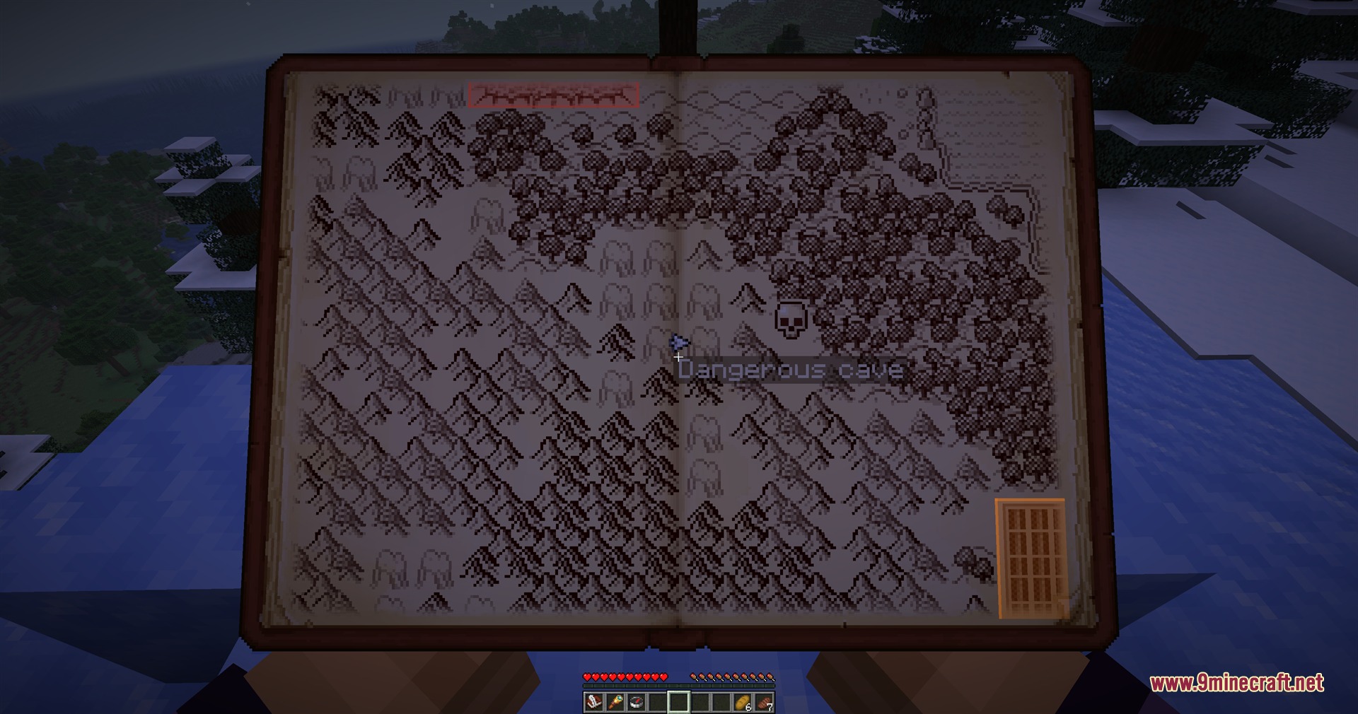 Player holding a hand drawn map book showing mountains and a dangerous cave