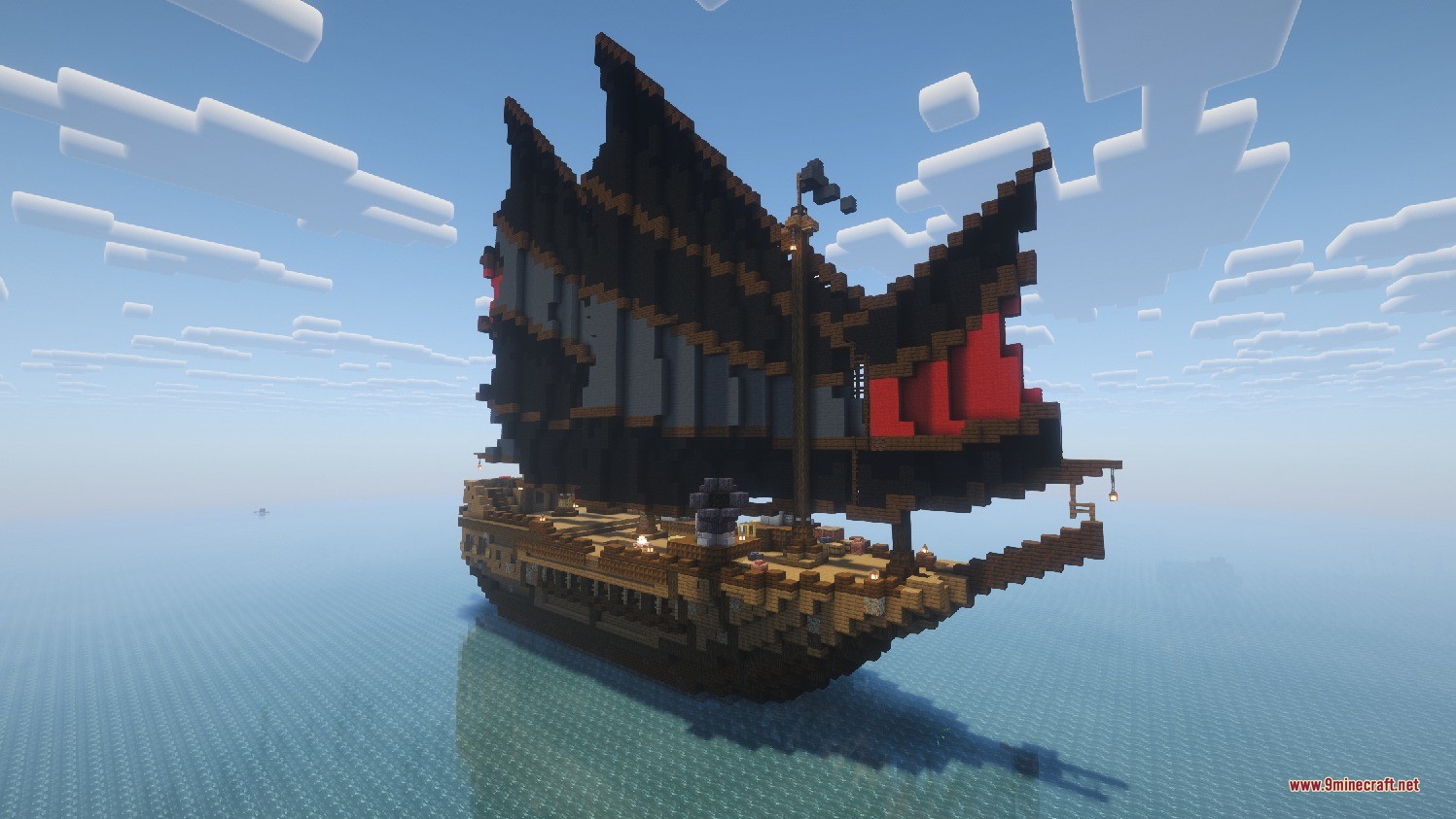 Large wooden pirate ship with black sails floating on the open ocean