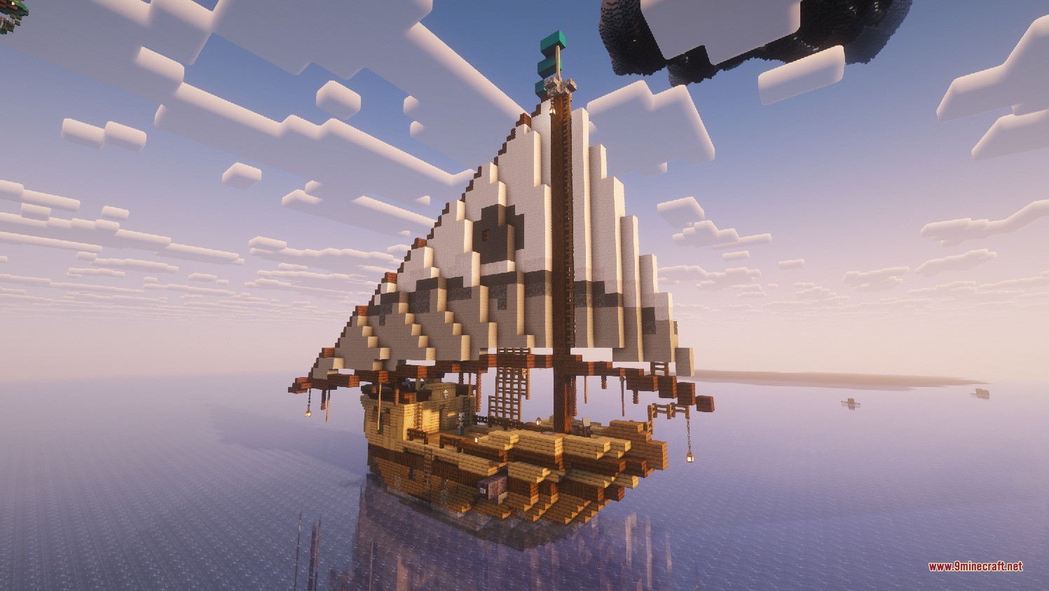 A small wooden ship with white sails floating on a calm sea