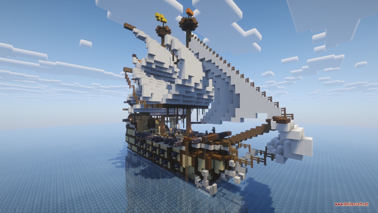 A massive wooden sailing ship with white sails floating on the deep ocean