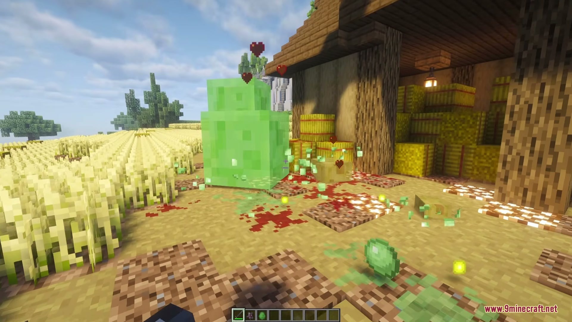 Iron's Simple Blood Mod Screenshot 2 Green slime jumping near red blood stains on the ground near hay