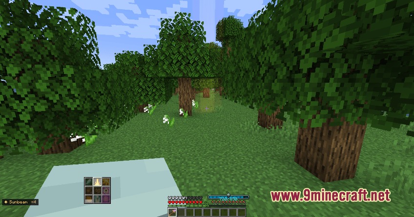 Player holding a magic staff in a forest with custom spell interface