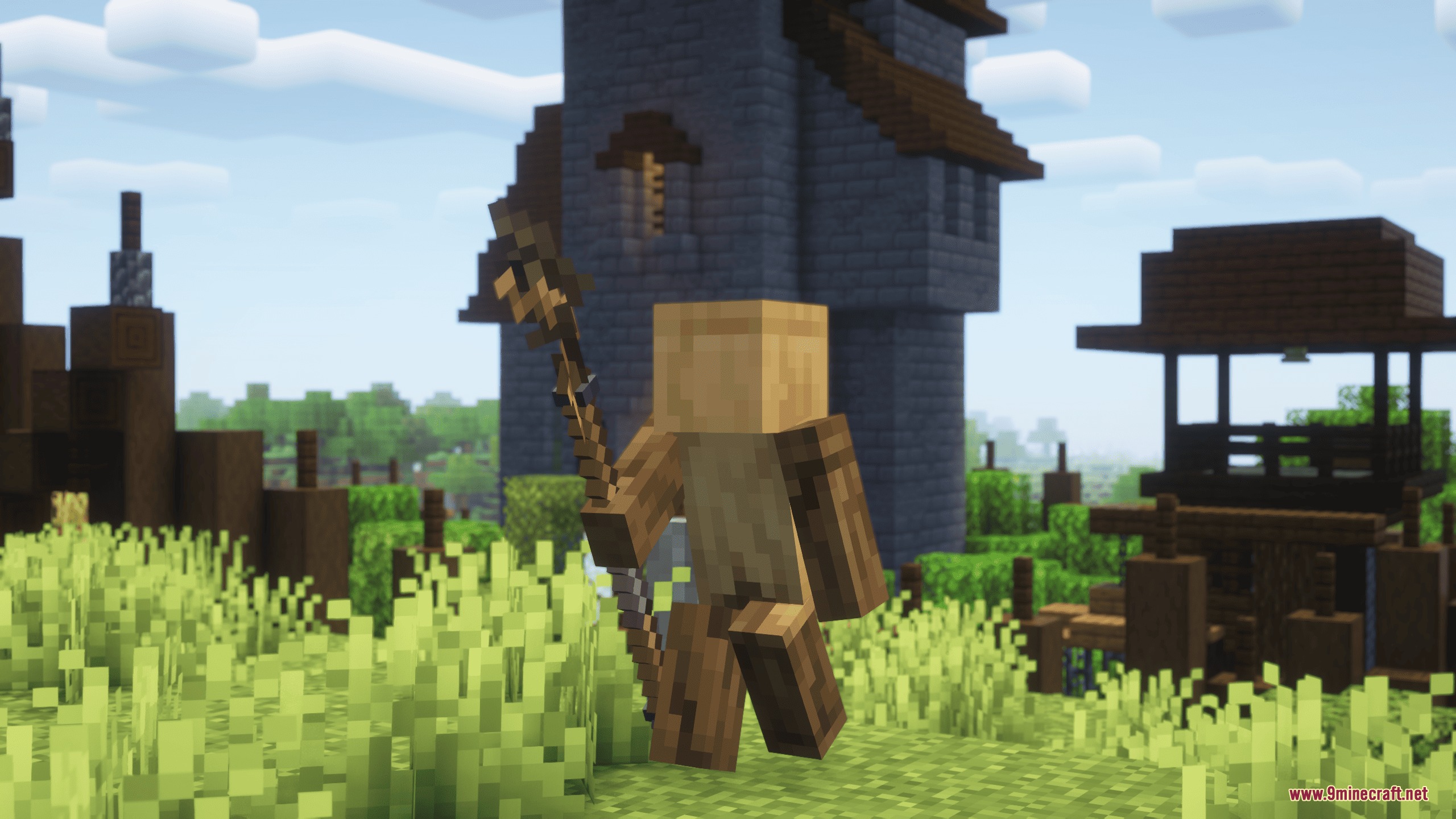 Iron's Spells 'n Spellbooks Reimagined Resource Pack Screenshot 4 Wooden figure holding a detailed magic staff in a lush green field