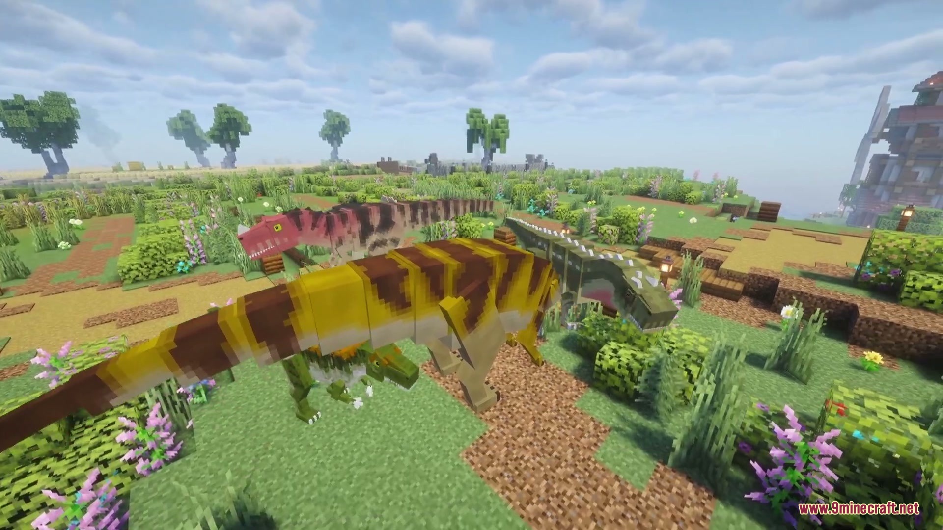 Jurassic Revived Mod Screenshot 2 Various carnivorous dinosaurs roaming through a lush green field with flowers and bushes