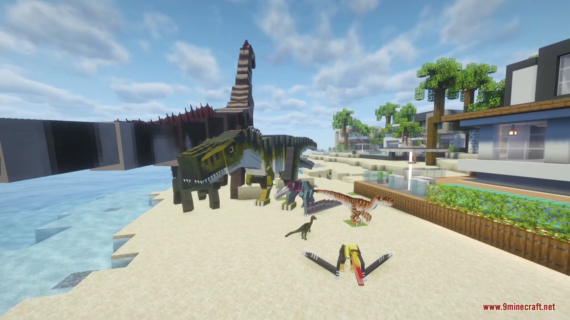 Jurassic Revived Mod Screenshot 4 A group of prehistoric creatures gathered on a sandy beach near modern buildings