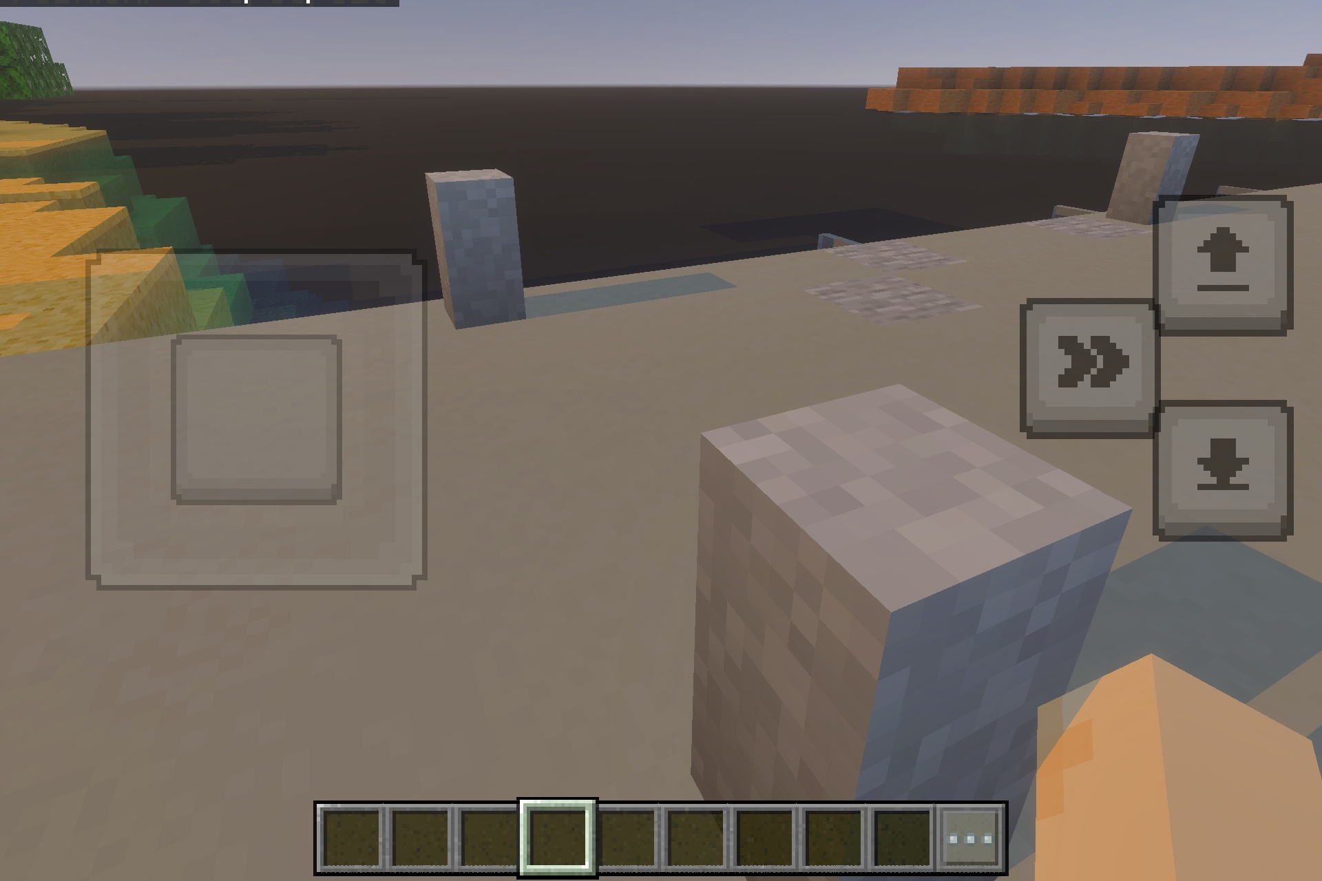 Stone blocks placed along a shoreline overlooking a vast body of water