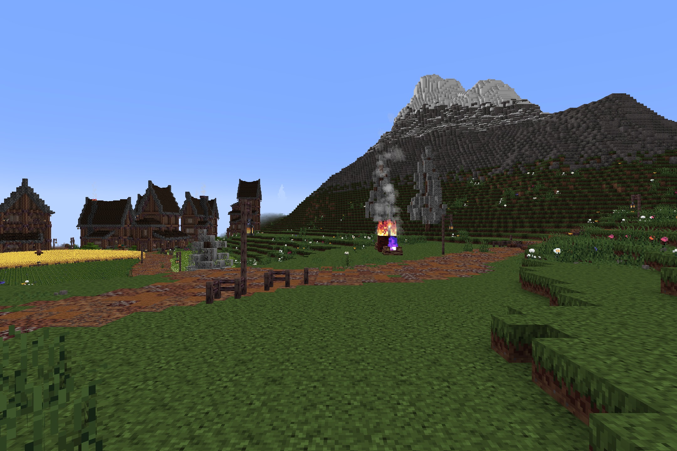 KDCraft~Fantastic Journey Resource Pack Screenshot 1 A medieval village with a dirt path leading towards a large snowy mountain