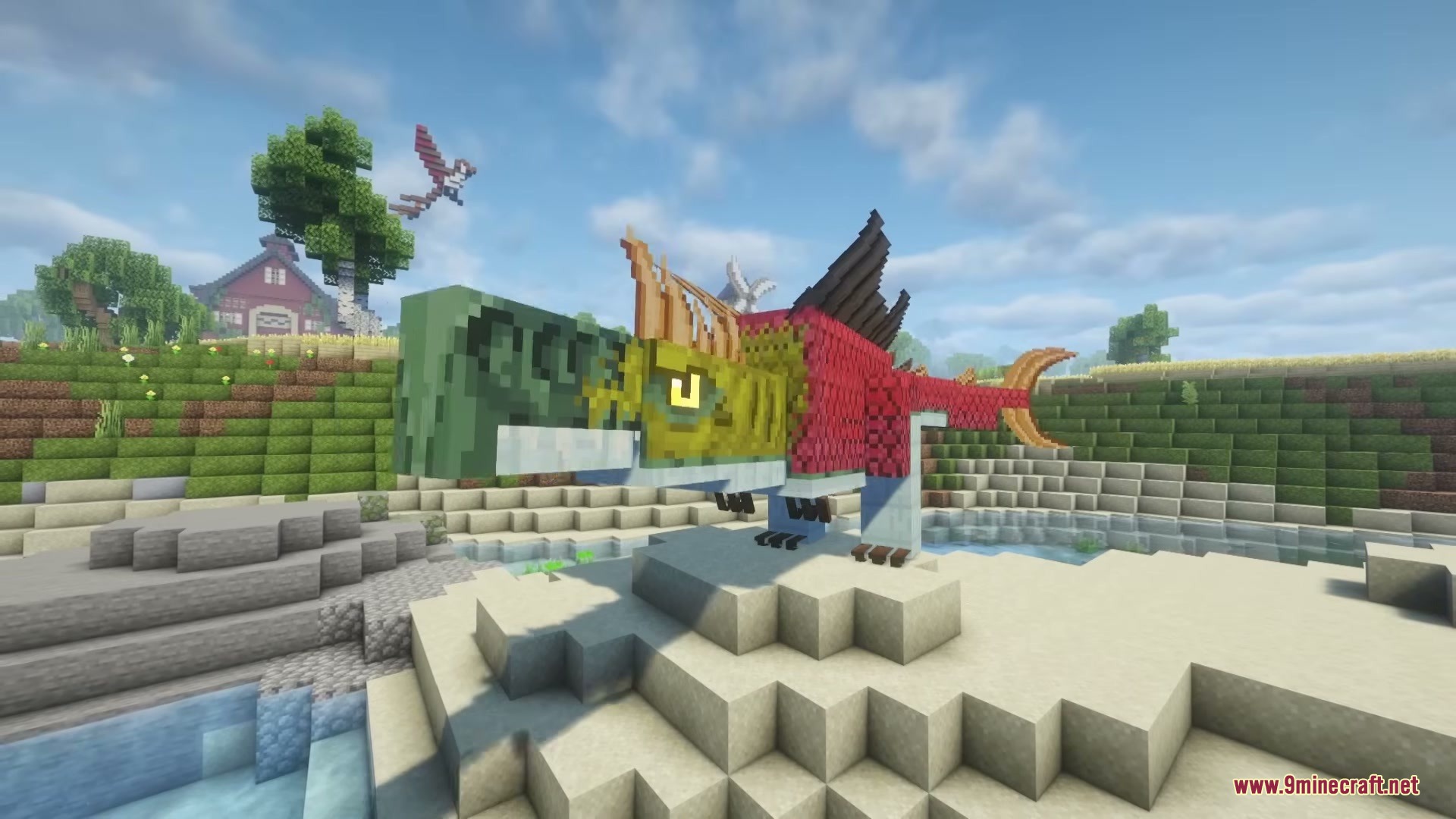 A giant colorful fish creature stands on a sandy beach near water