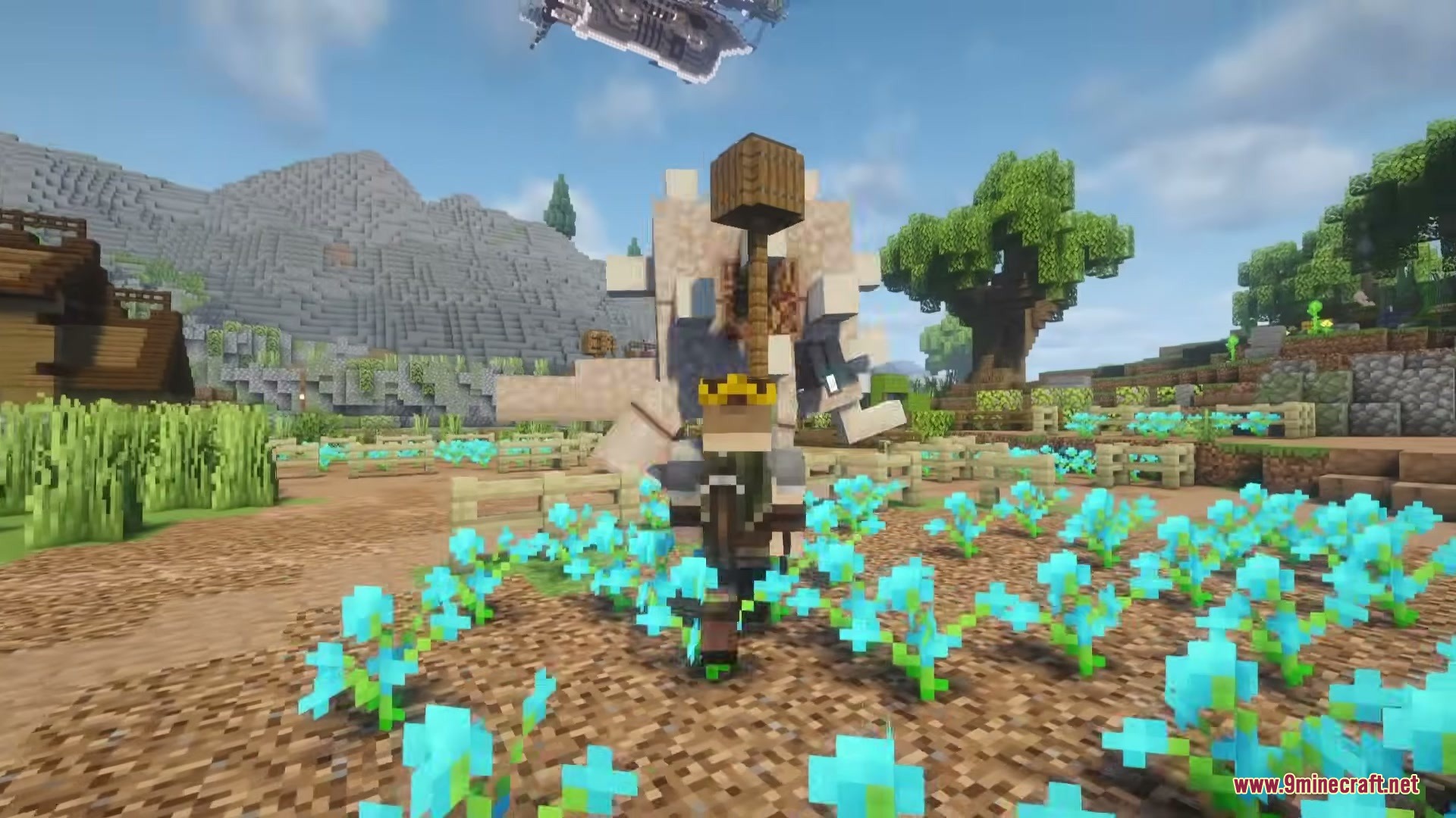 A player character stands in a flower field with the massive Anglopine monster