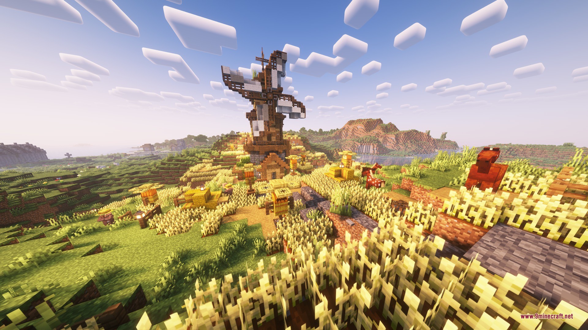 Katters Structures Ambient Data Pack Screenshot 1 A large wooden windmill stands atop a hill surrounded by golden wheat fields