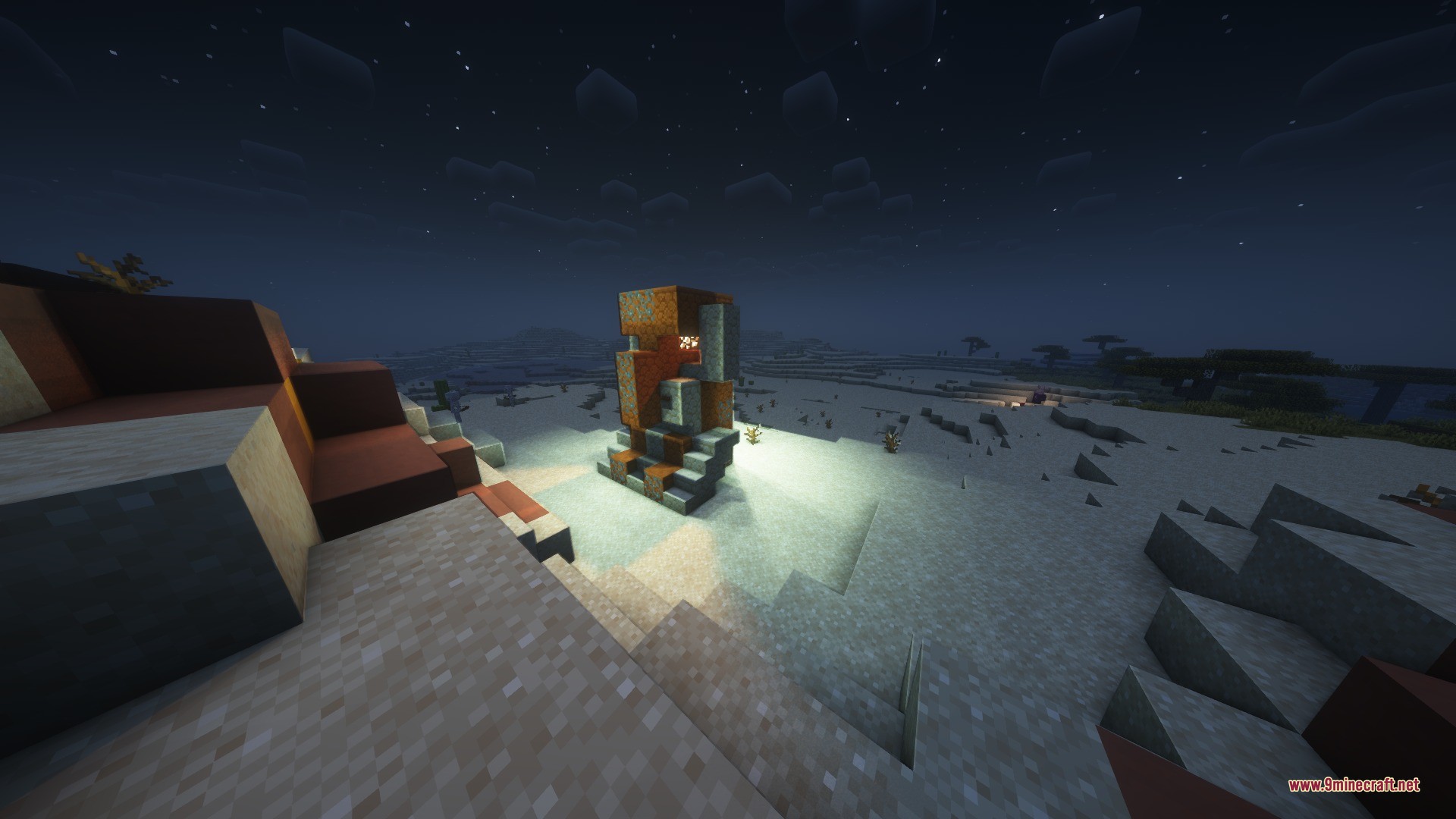 Katters Structures Ambient Data Pack Screenshot 4 A giant villager statue made of orange blocks in a desert biome at night