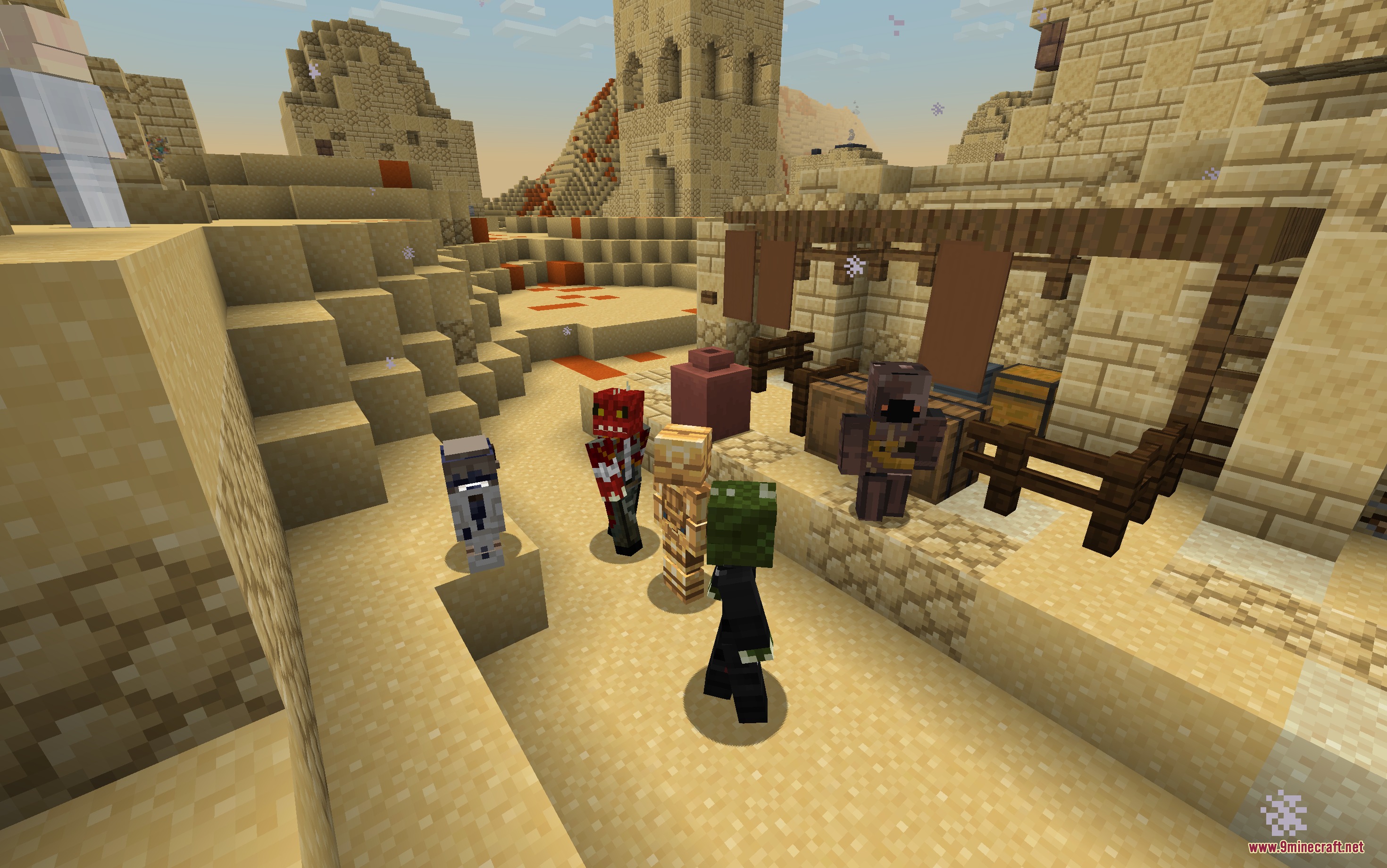 Alien villagers standing together in a desert village made of sandstone blocks