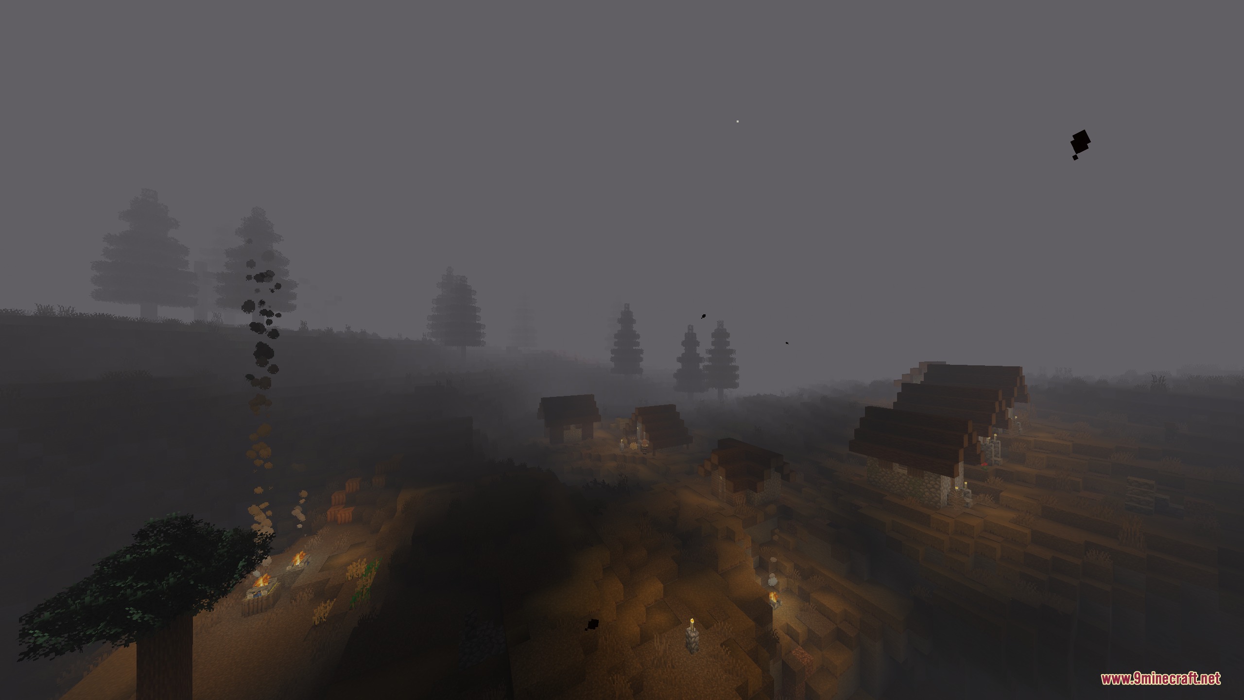 A small village surrounded by thick fog and floating dark particles at night