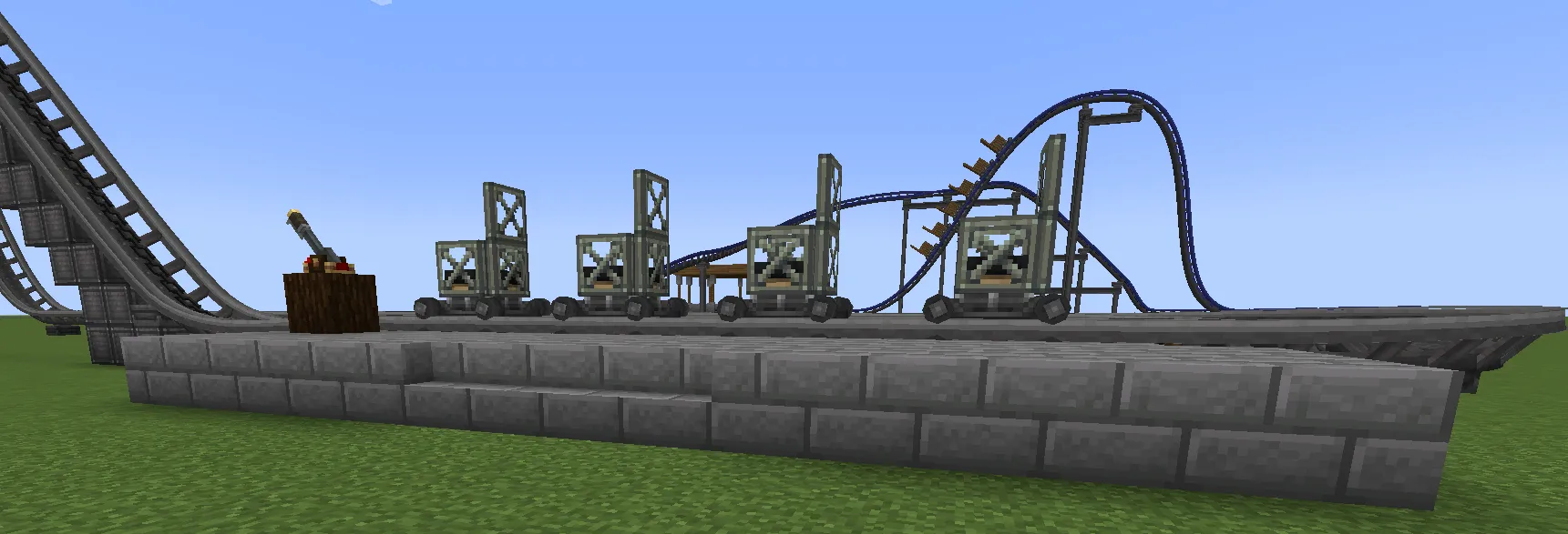 Large Drop Coaster Schematic Screenshots 2 Four minecarts waiting on the track at a stone brick loading station
