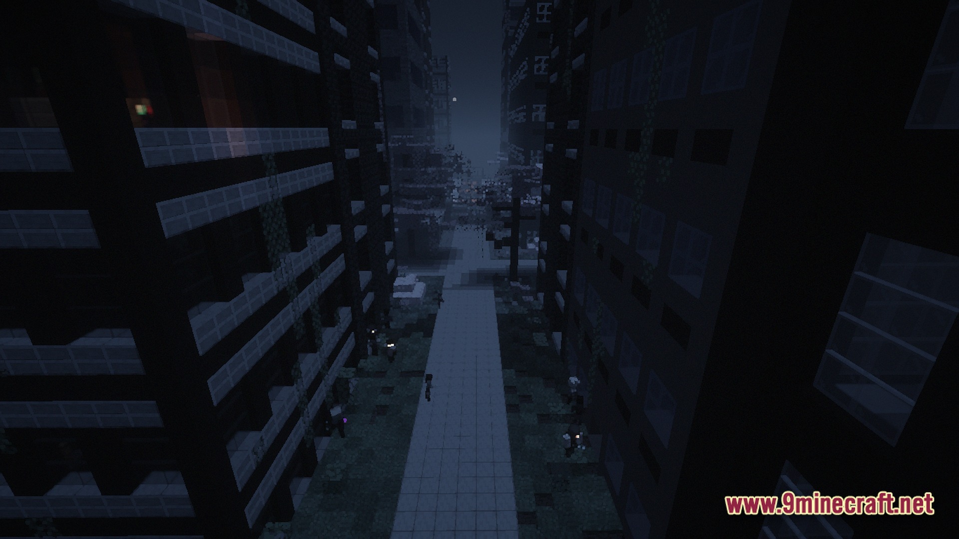 A dark, abandoned city street at night featuring tall buildings and overgrown vegetation