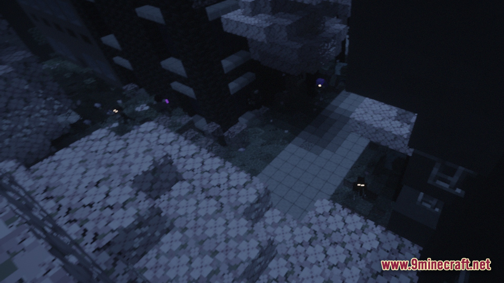 Hostile mobs with glowing eyes wander through a dark, ruined urban environment at night