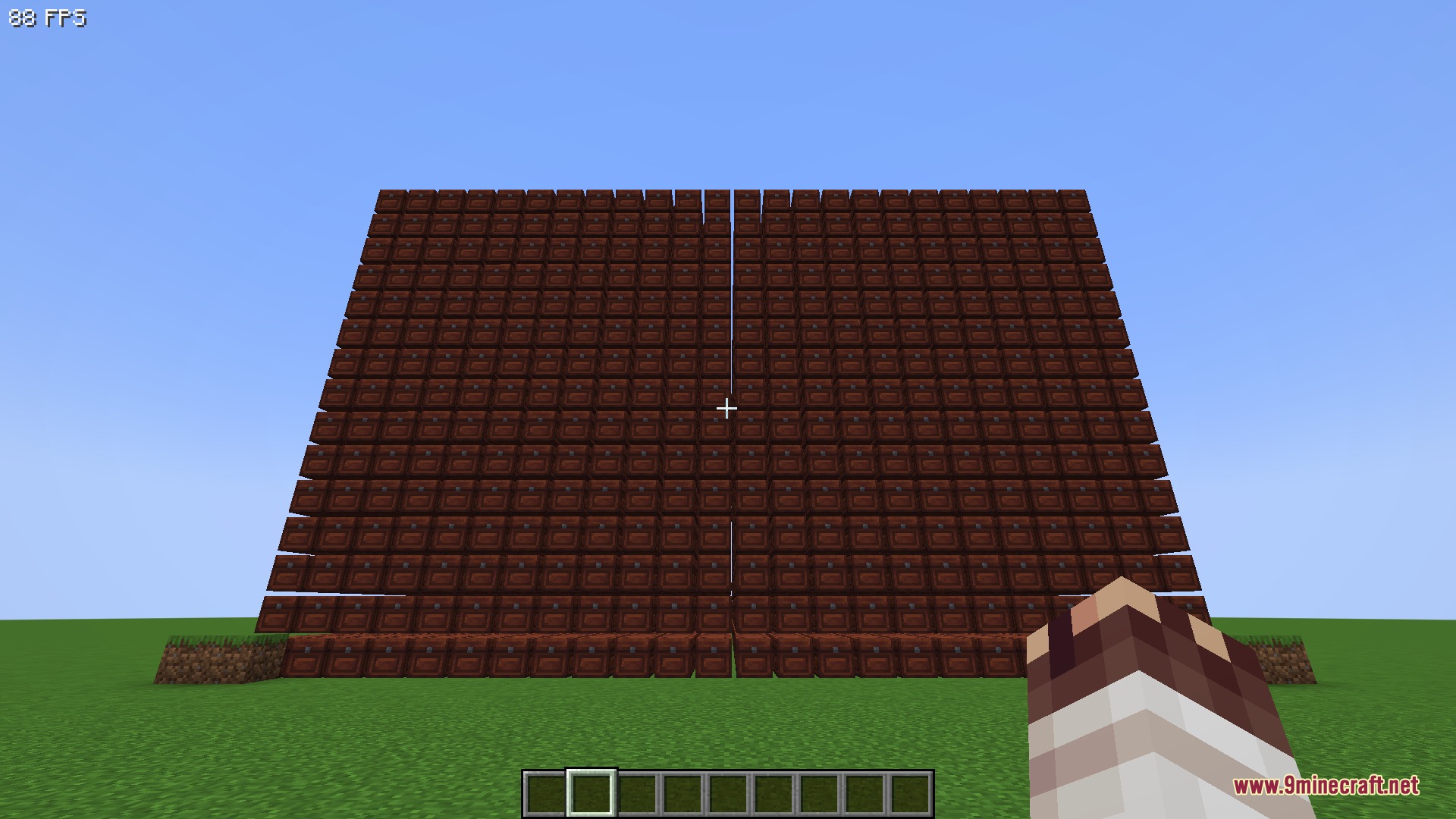 Hundreds of wooden chests stacked to form a massive wall in Minecraft
