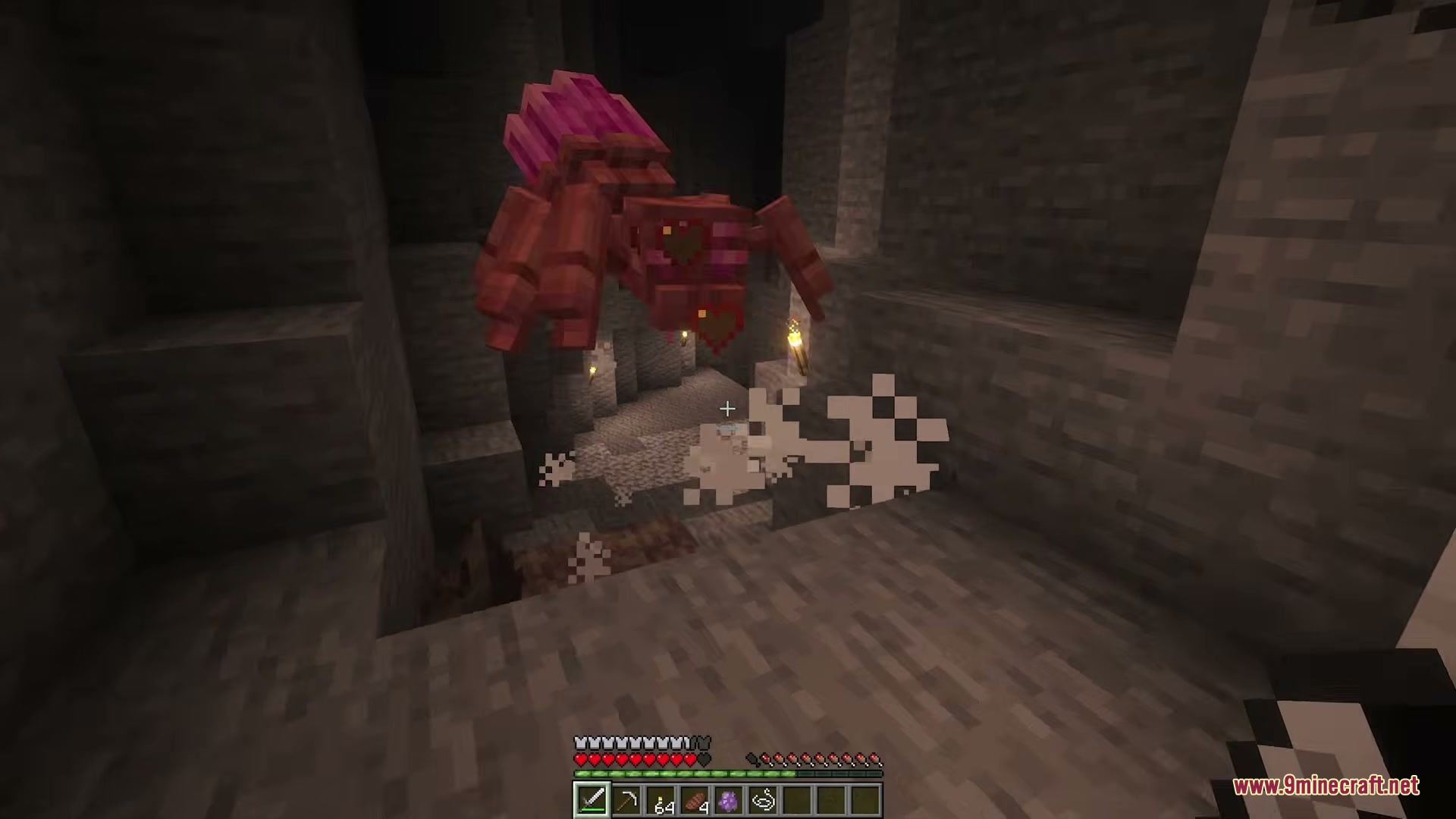 Legendary Farming Mod Screenshot 4 A giant reddish spider hanging from the ceiling inside a dark cave
