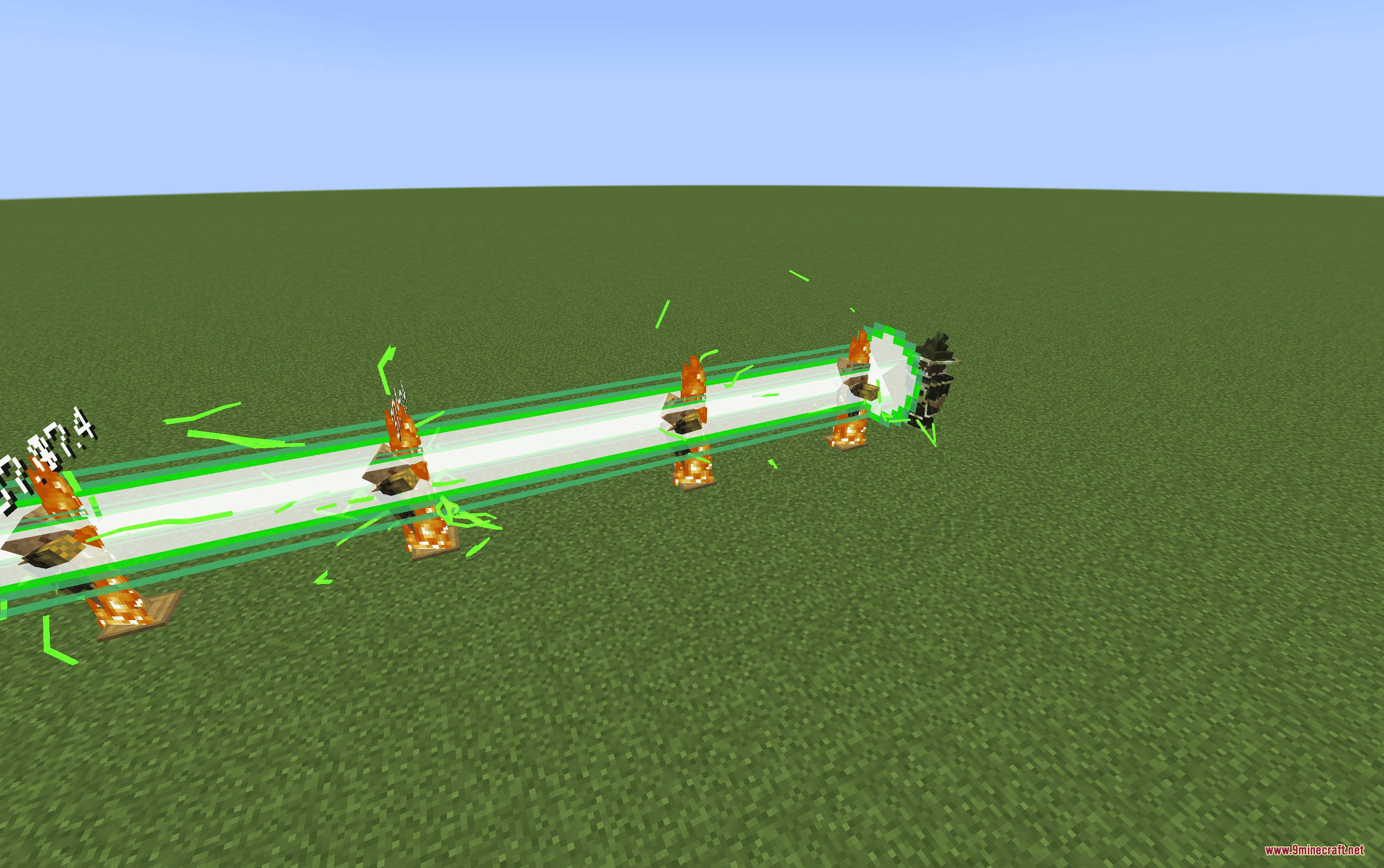 A horizontal green energy beam blasts through multiple burning armor stands on grass
